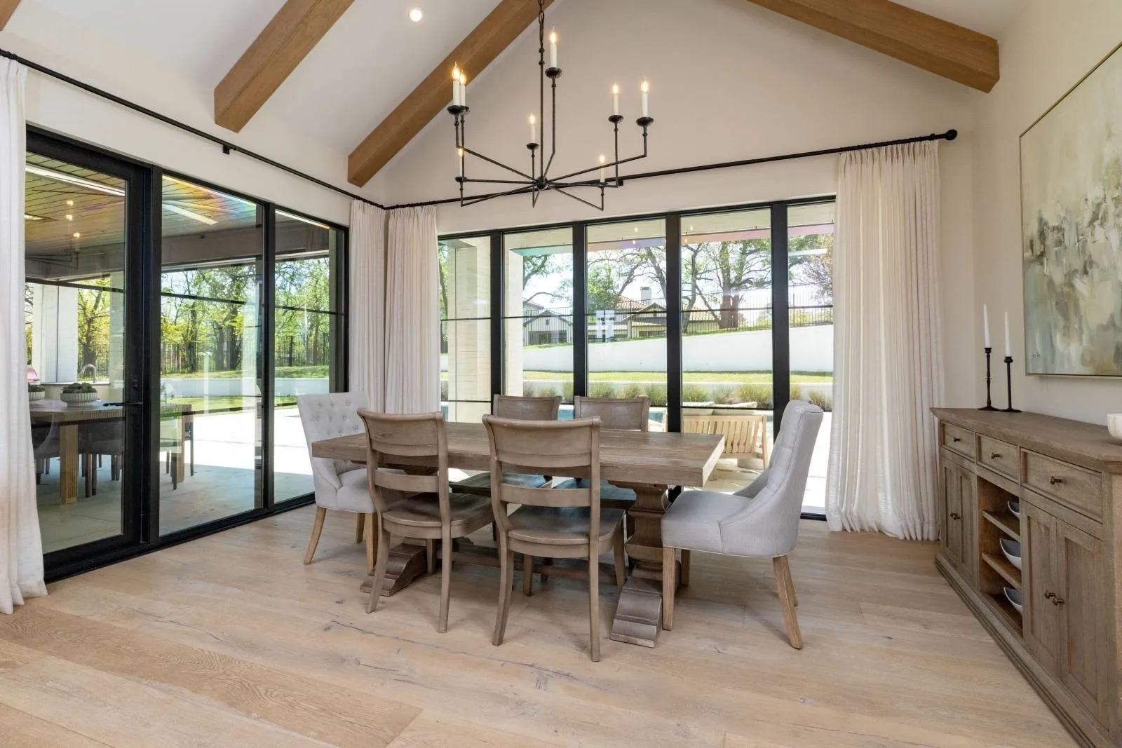 The dining room with it's beautiful beams overlooks the pool and backyard living space.