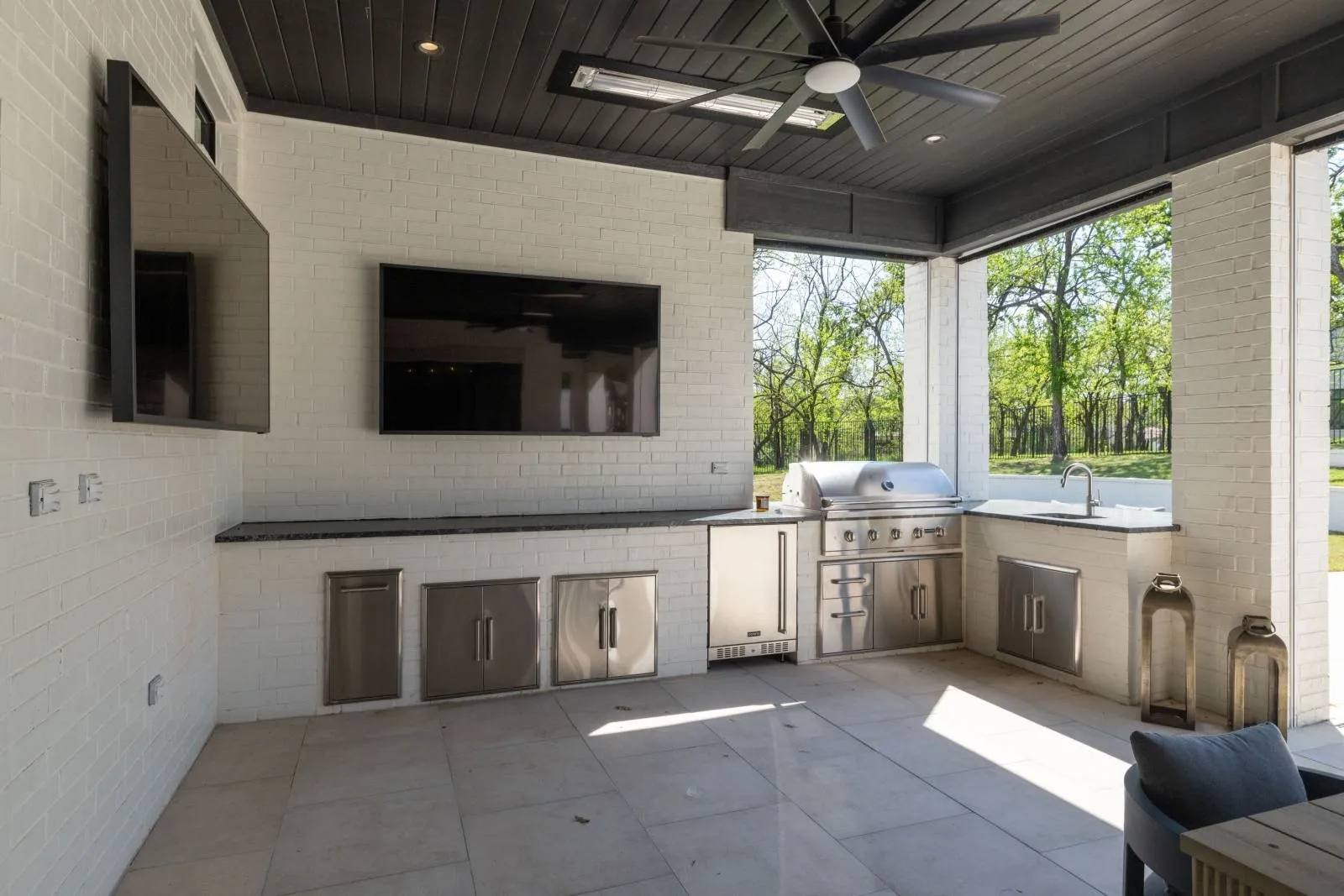 Back patio ready to entertain or sit with you morning coffee!  Has built in heaters and screens that come down to enclose the space
