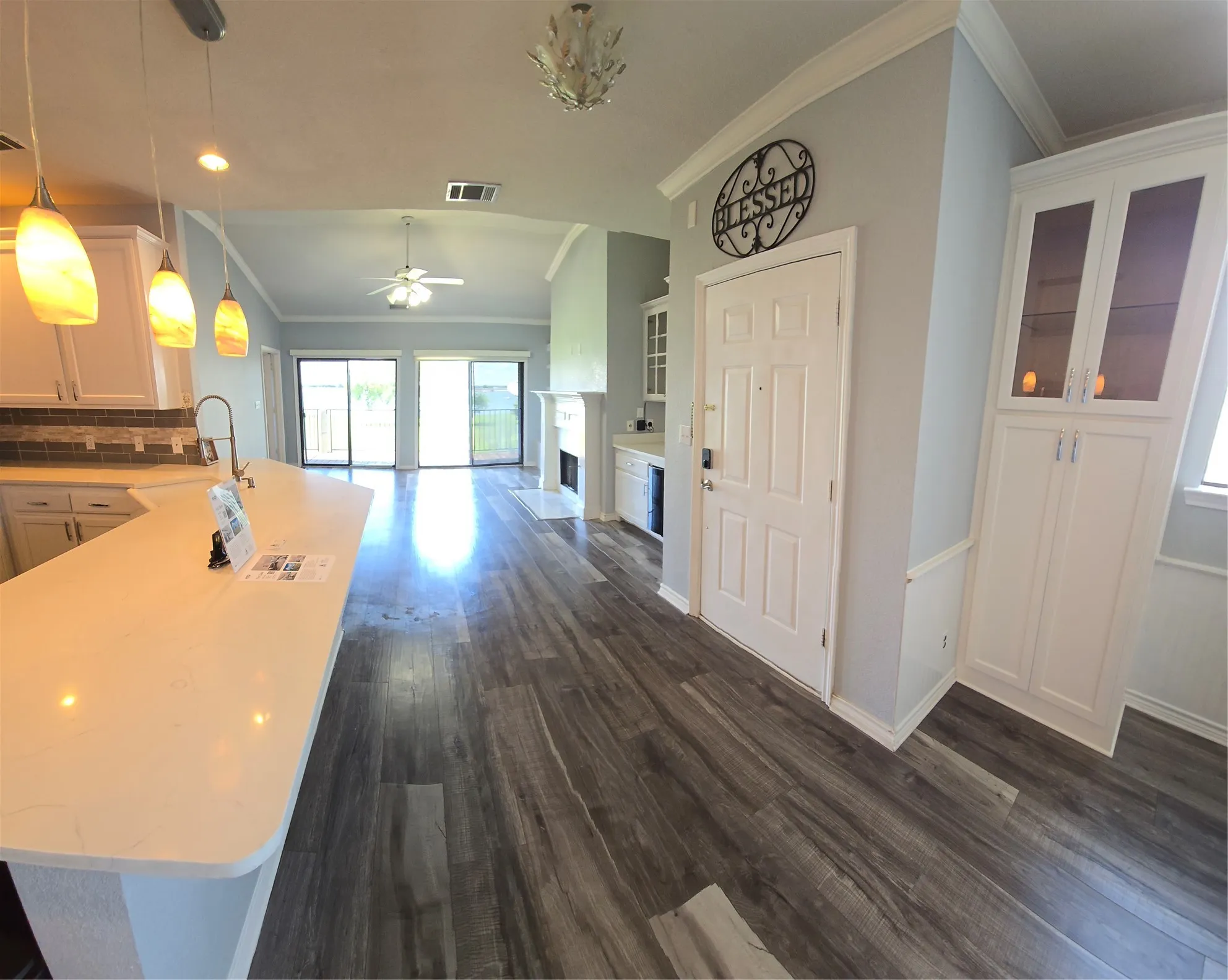 Open-concept living area with wood-finish flooring extending throughout
