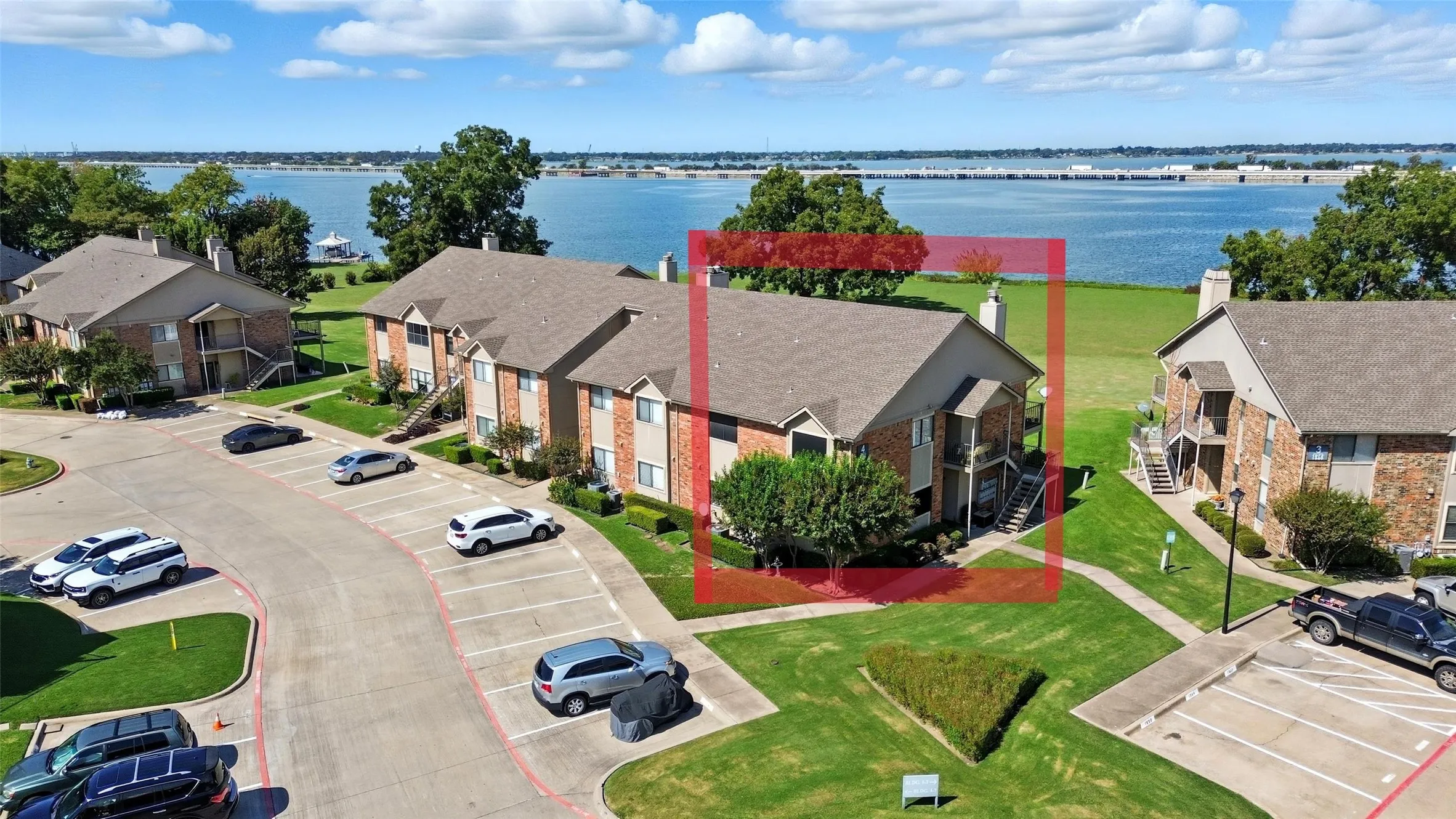 Aerial perspective of suburban area featuring a large body of water