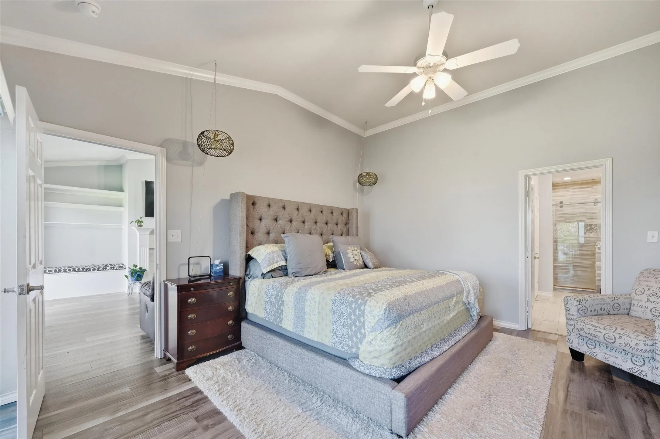 Bedroom with ornamental molding, lofted ceiling, wood finished floors, and ceiling fan