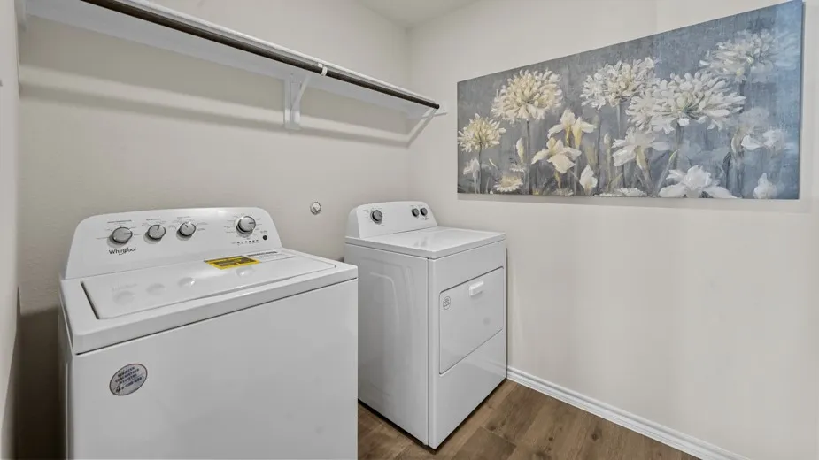 Laundry area featuring dark wood-style flooring and separate washer and dryer