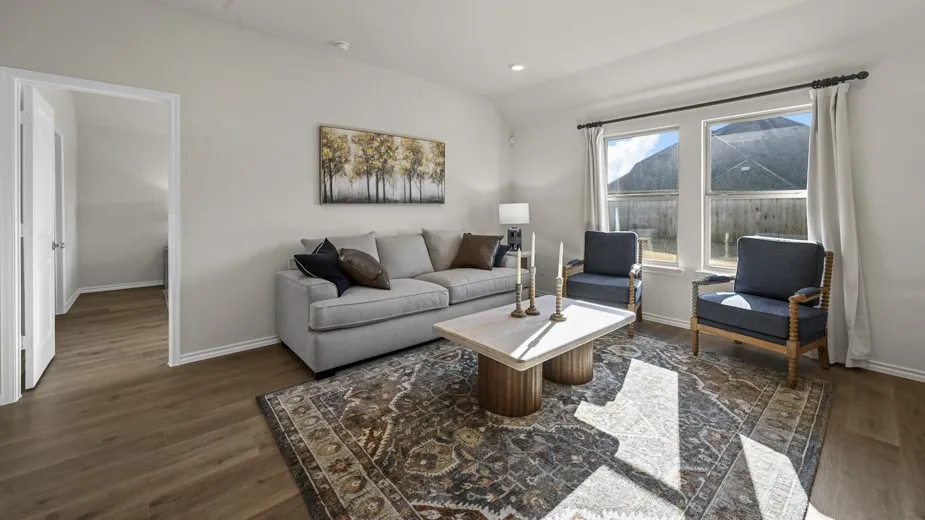 Living area featuring dark wood finished floors, recessed lighting, and vaulted ceiling