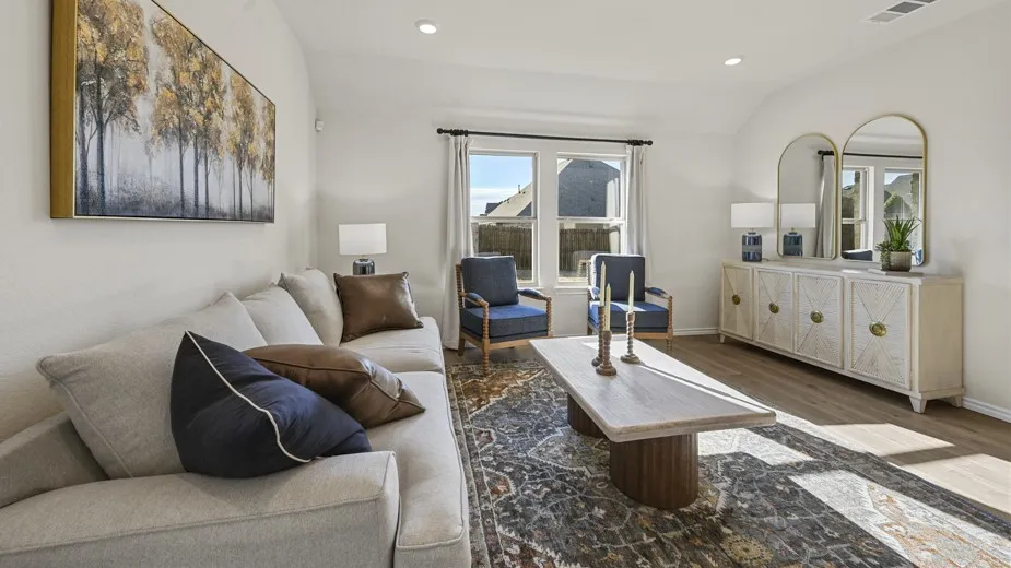 Living room featuring vaulted ceiling, recessed lighting, and wood finished floors