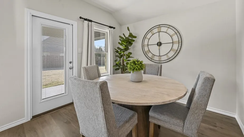 Dining space featuring vaulted ceiling and wood finished floors
