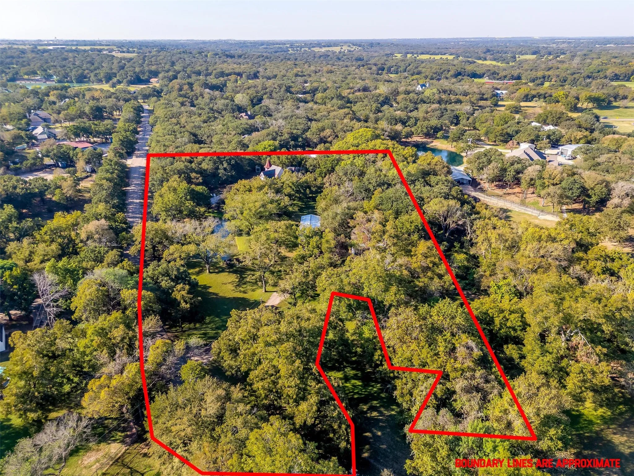 View of property location with property parcel outlined and a forest