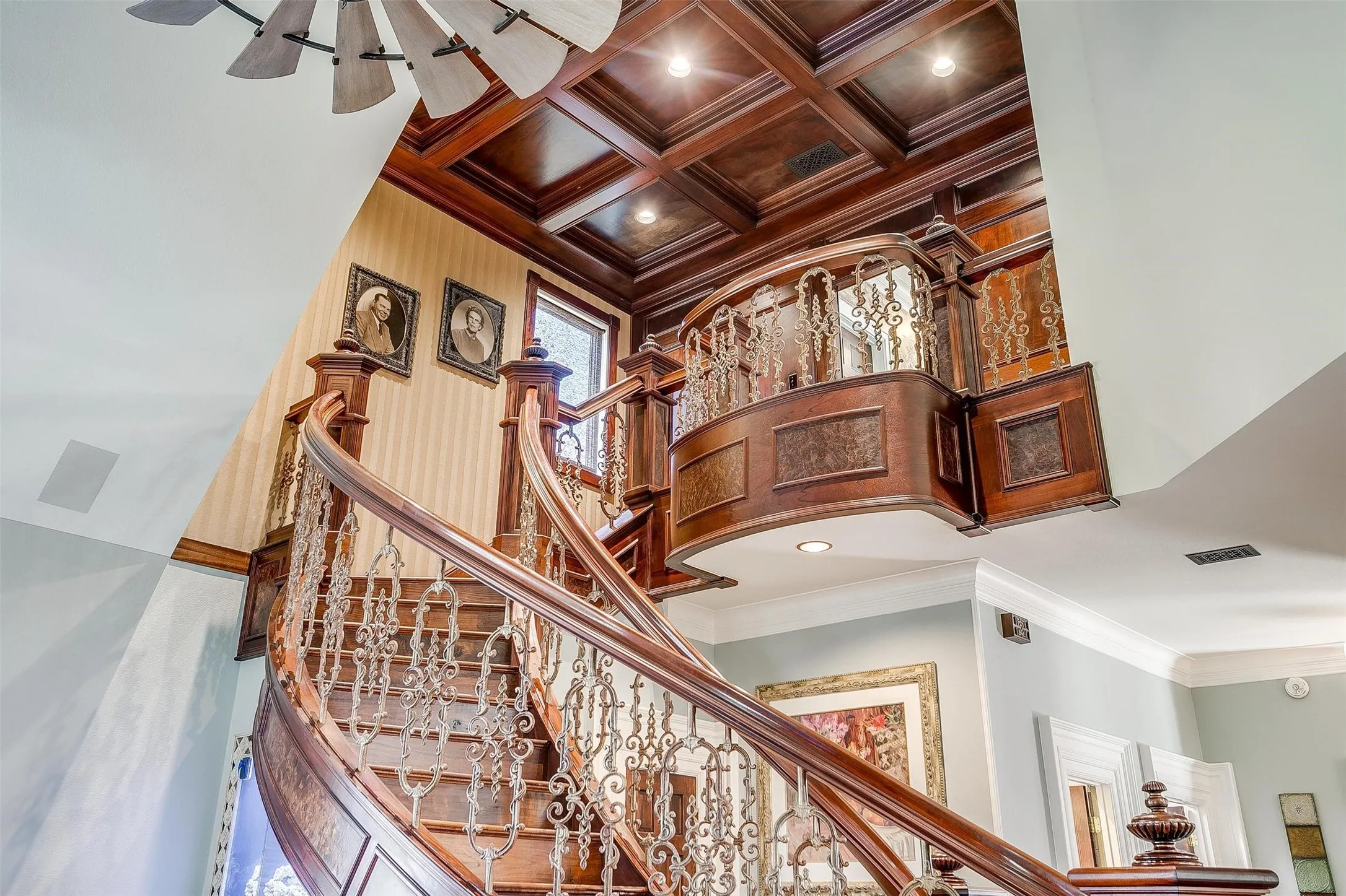 Stairway with ornamental molding, recessed lighting, and high coffered ceiling