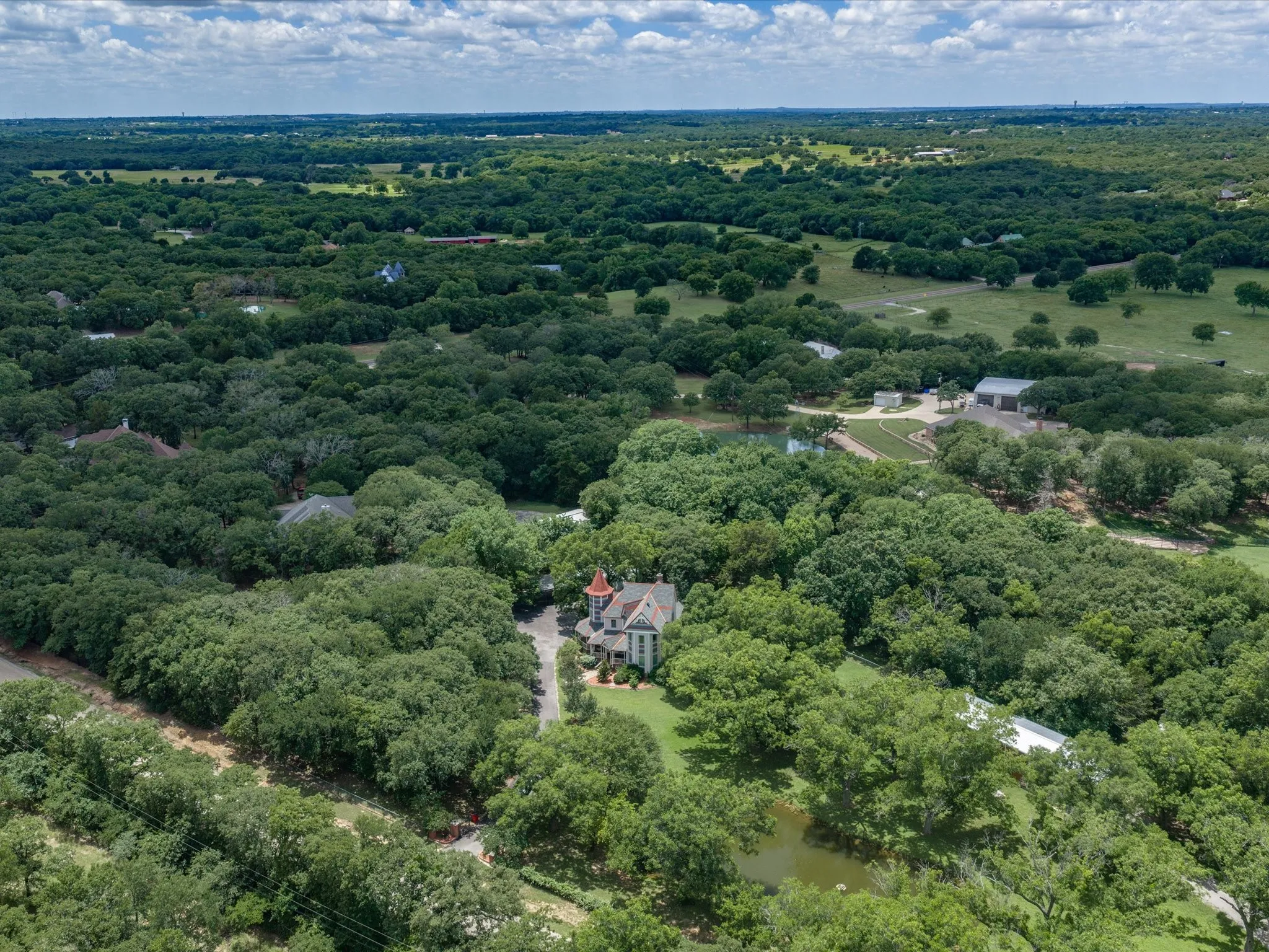 Expansive property featuring dense mature trees and open green spaces