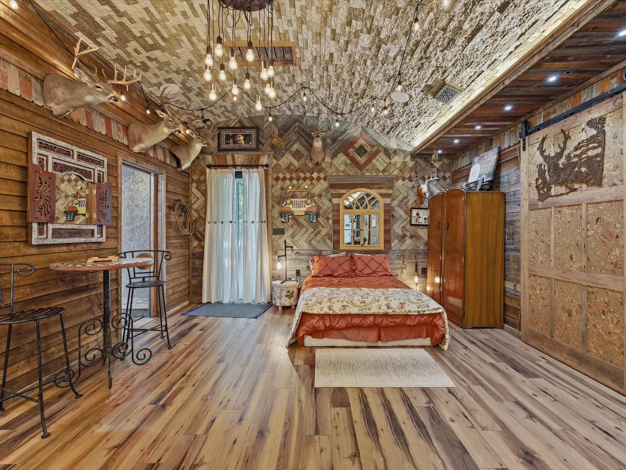Interior space featuring wood-finish flooring, wood-paneled walls, and a textured wood-plank ceiling