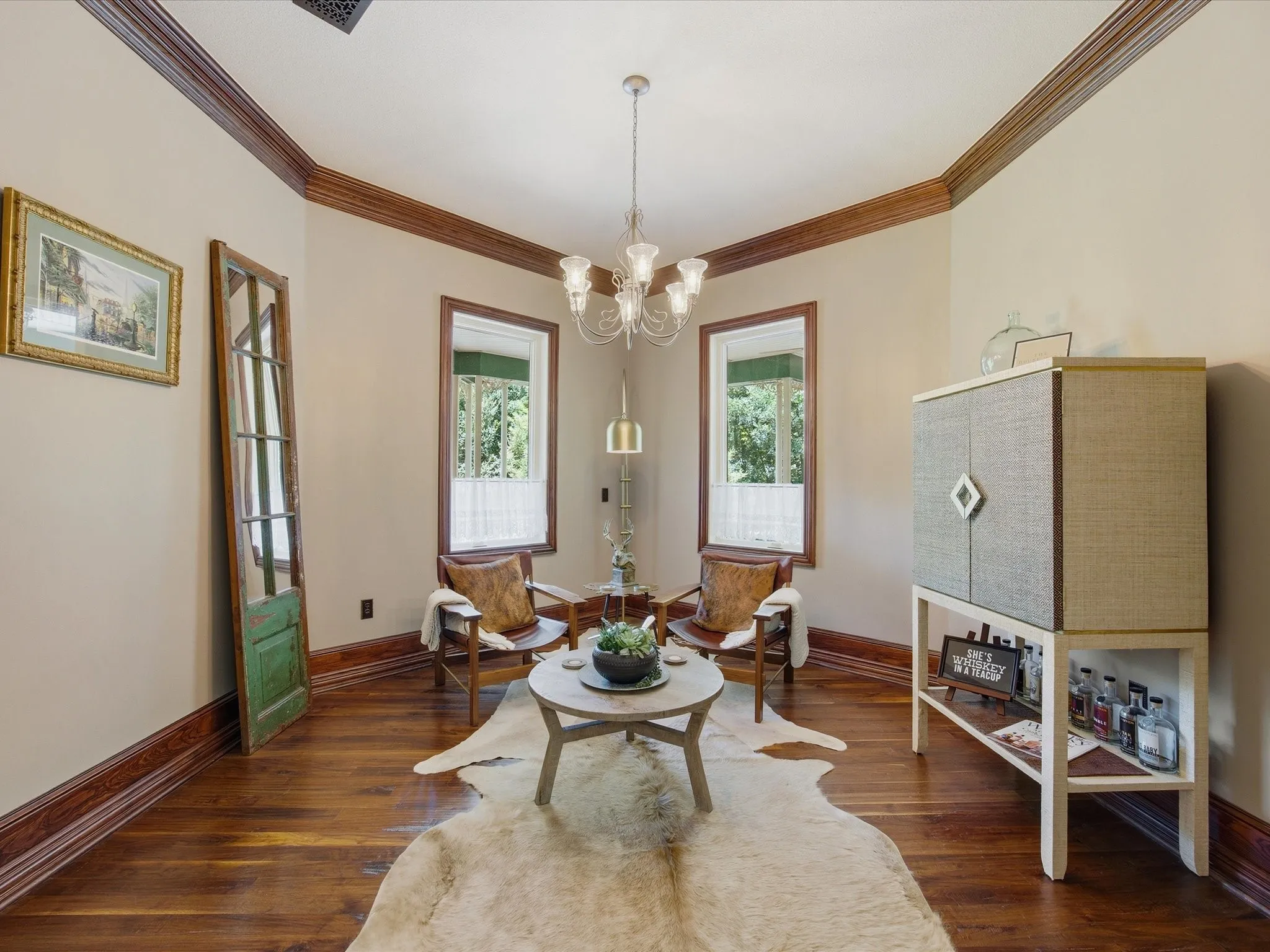 Wood-finish flooring throughout, complemented by dark wood baseboards and crown molding