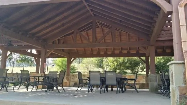 Surrounding community featuring a gazebo, outdoor dining space, and a patio