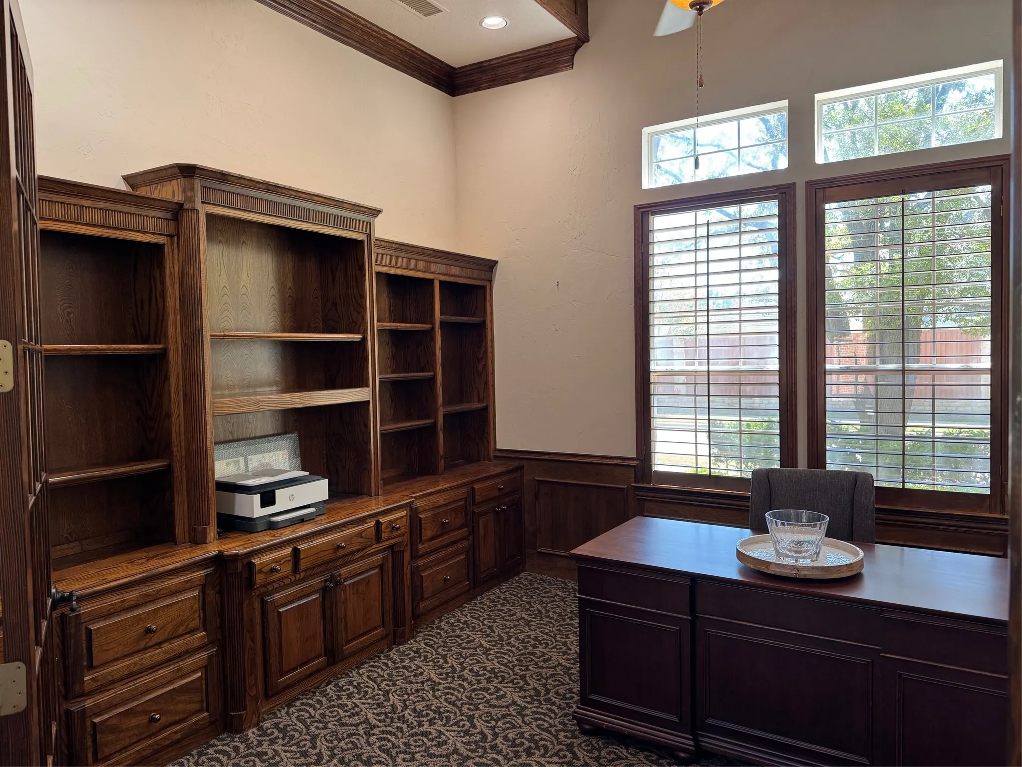 Office has wood shutters, built in cabinets and gas fireplace.