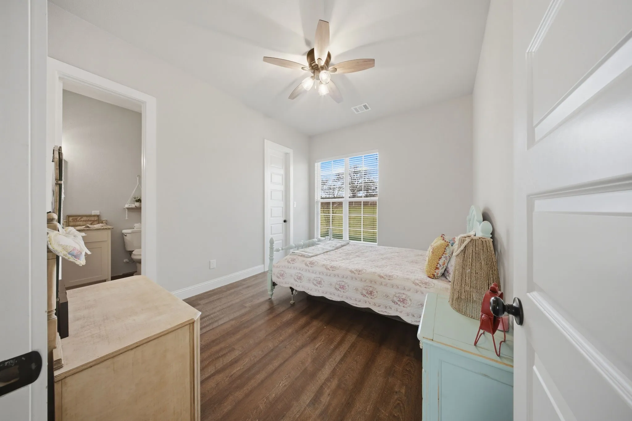 Bedroom featuring a ceiling fan and dark wood-type flooring