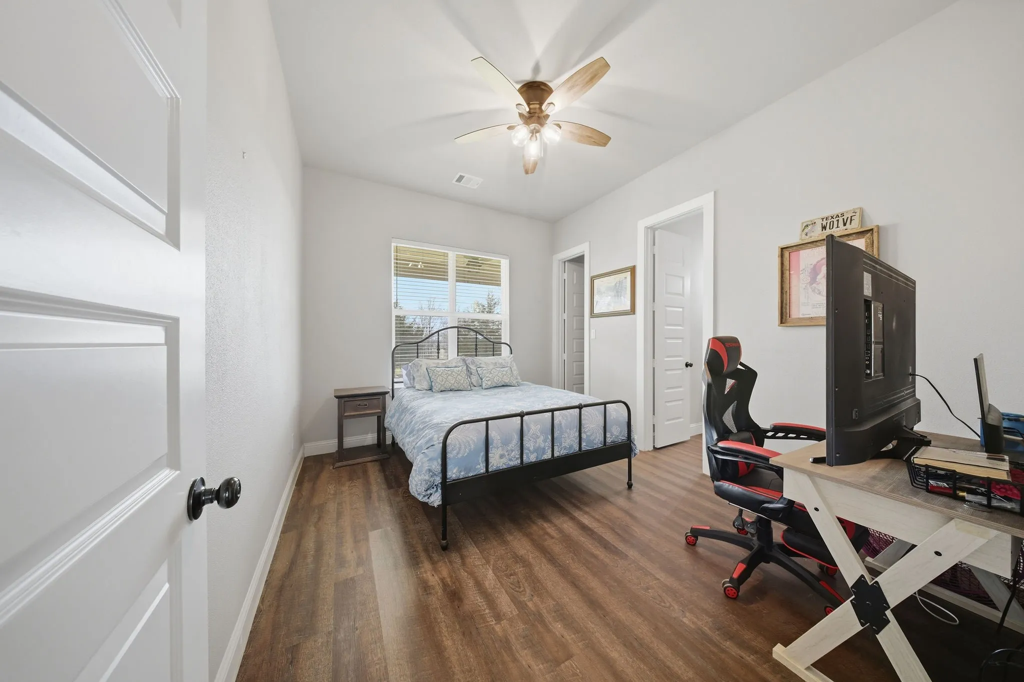 Bedroom with dark wood-style floors and ceiling fan