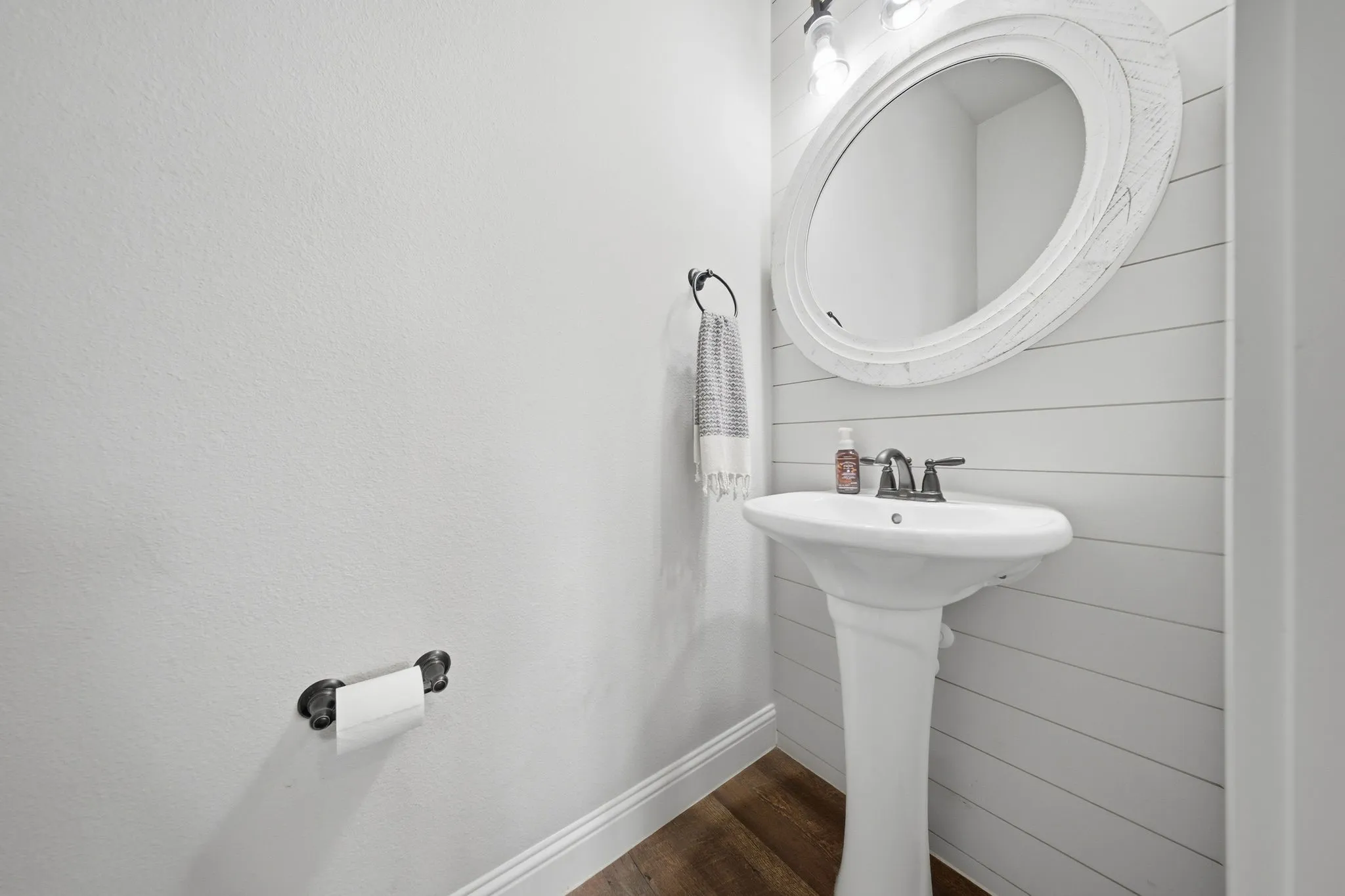 Bathroom featuring baseboards and dark wood-type flooring