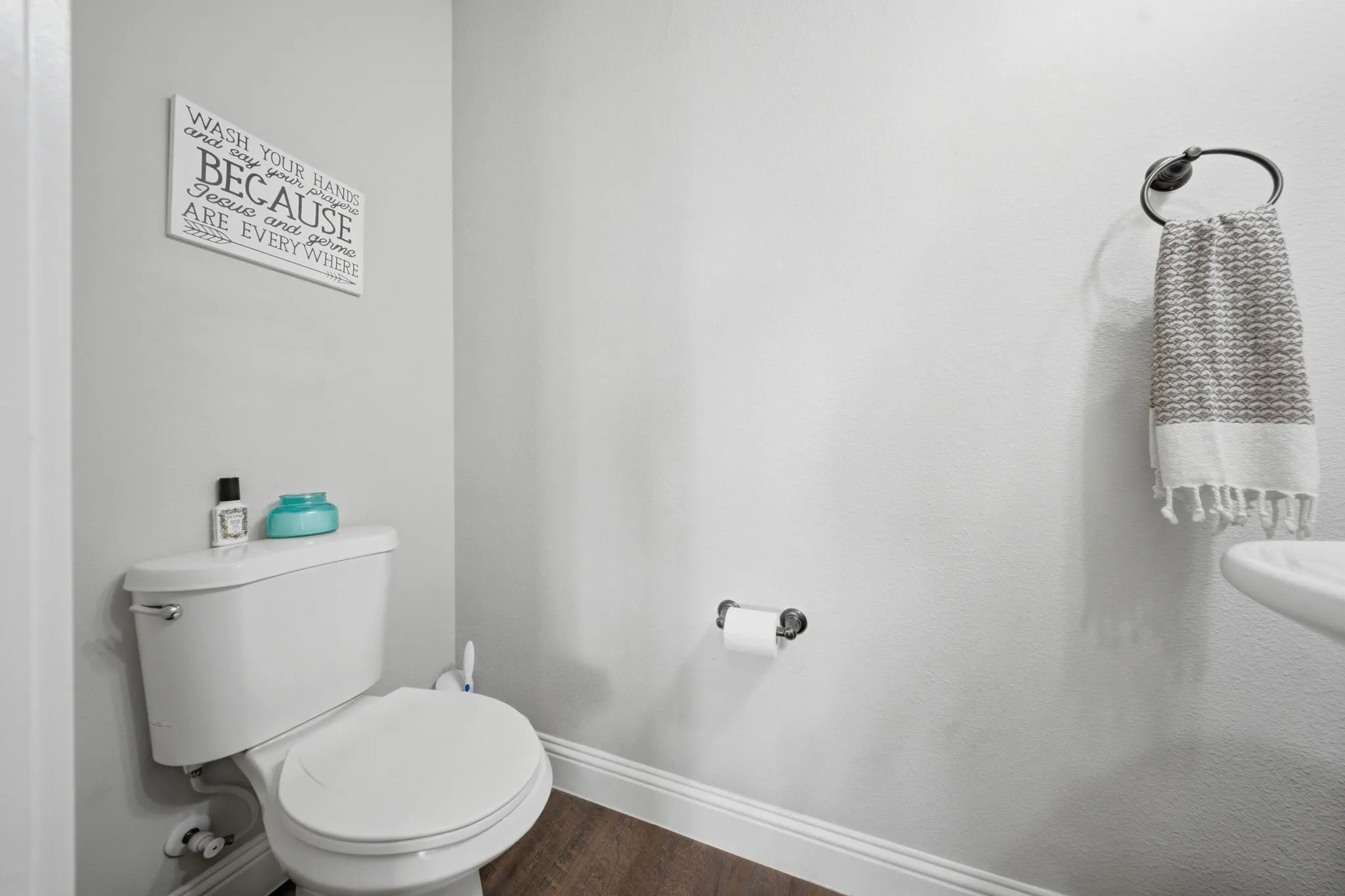 Bathroom with baseboards and dark wood-style floors