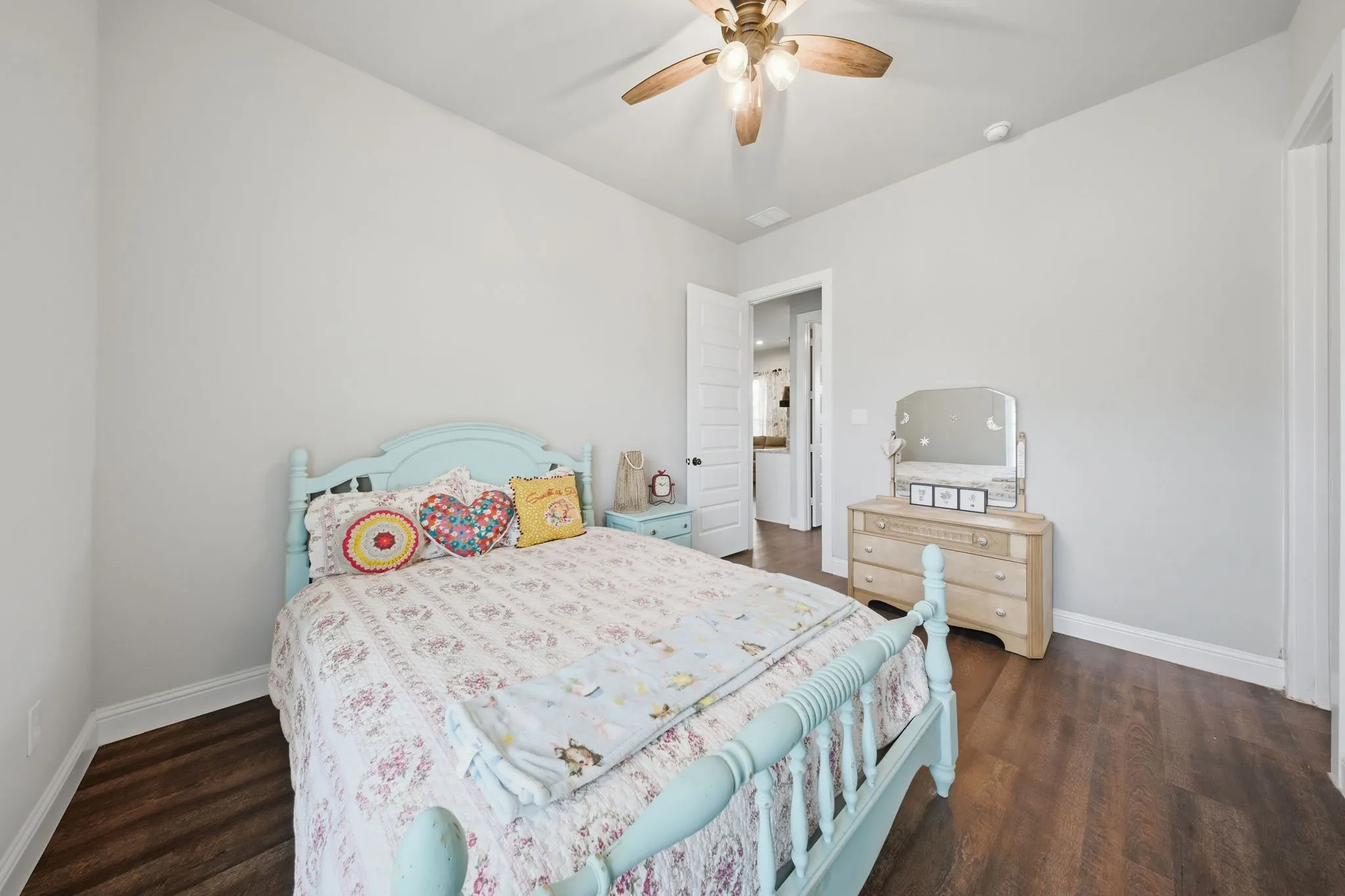 Bedroom with dark wood-style floors and ceiling fan