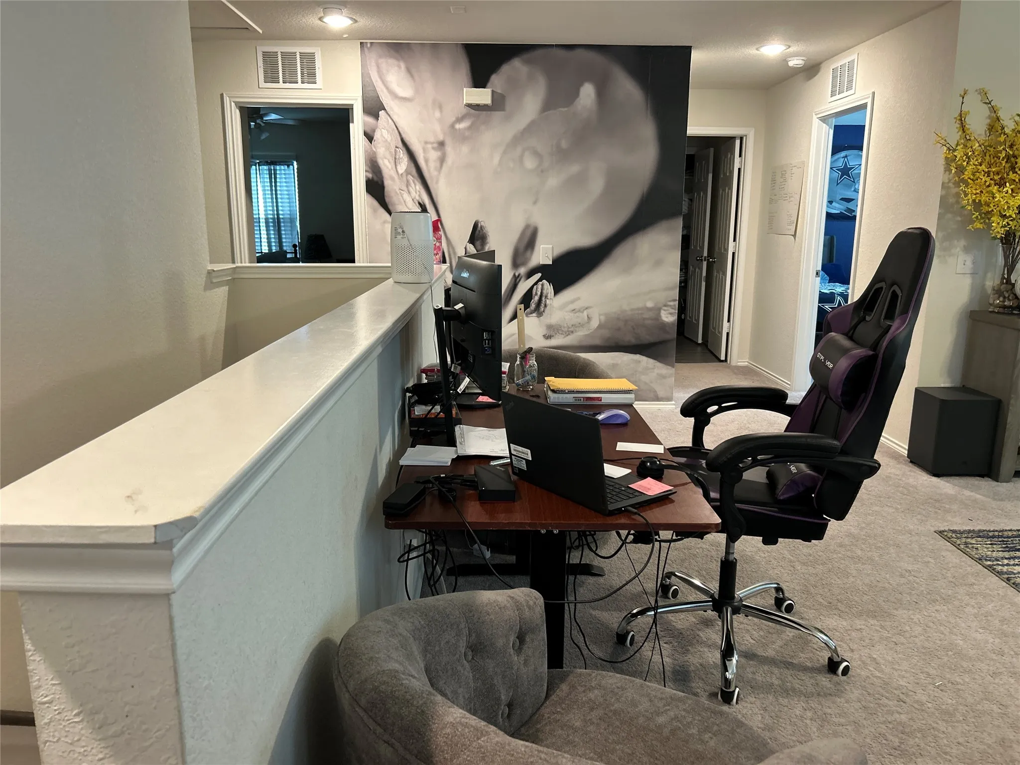Office featuring light colored carpet, a textured wall, and recessed lighting