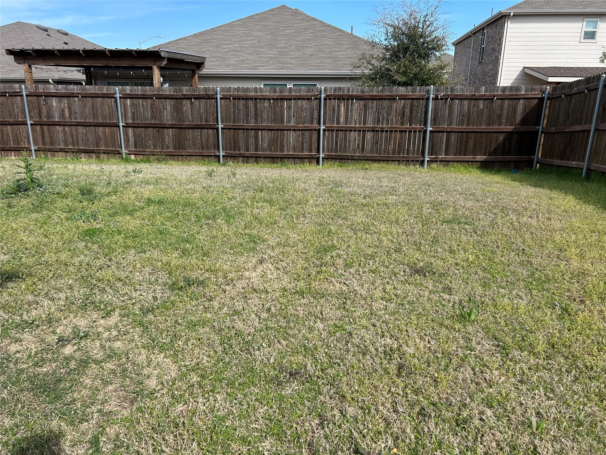 View of fenced backyard