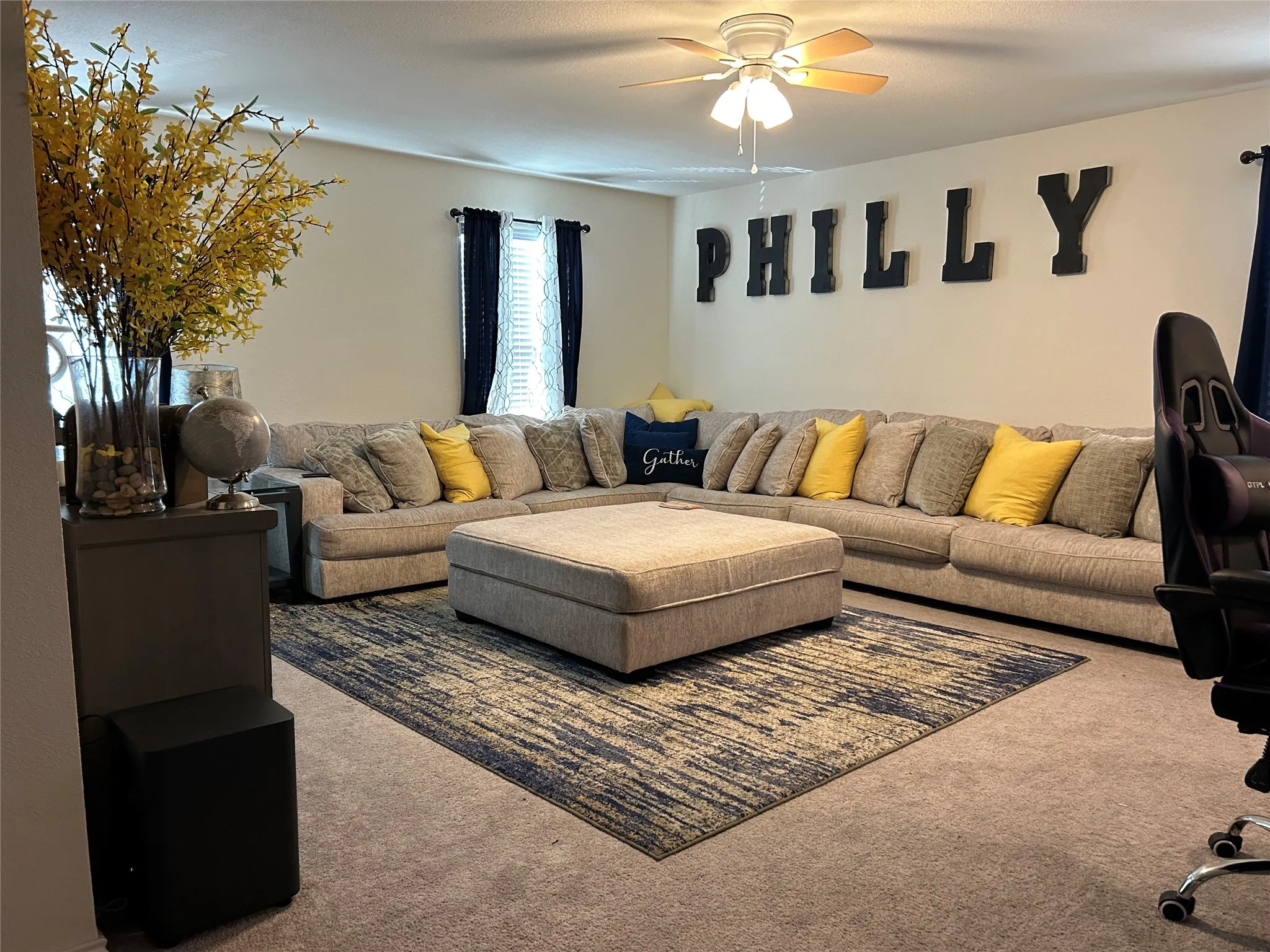 Living room featuring carpet flooring and ceiling fan