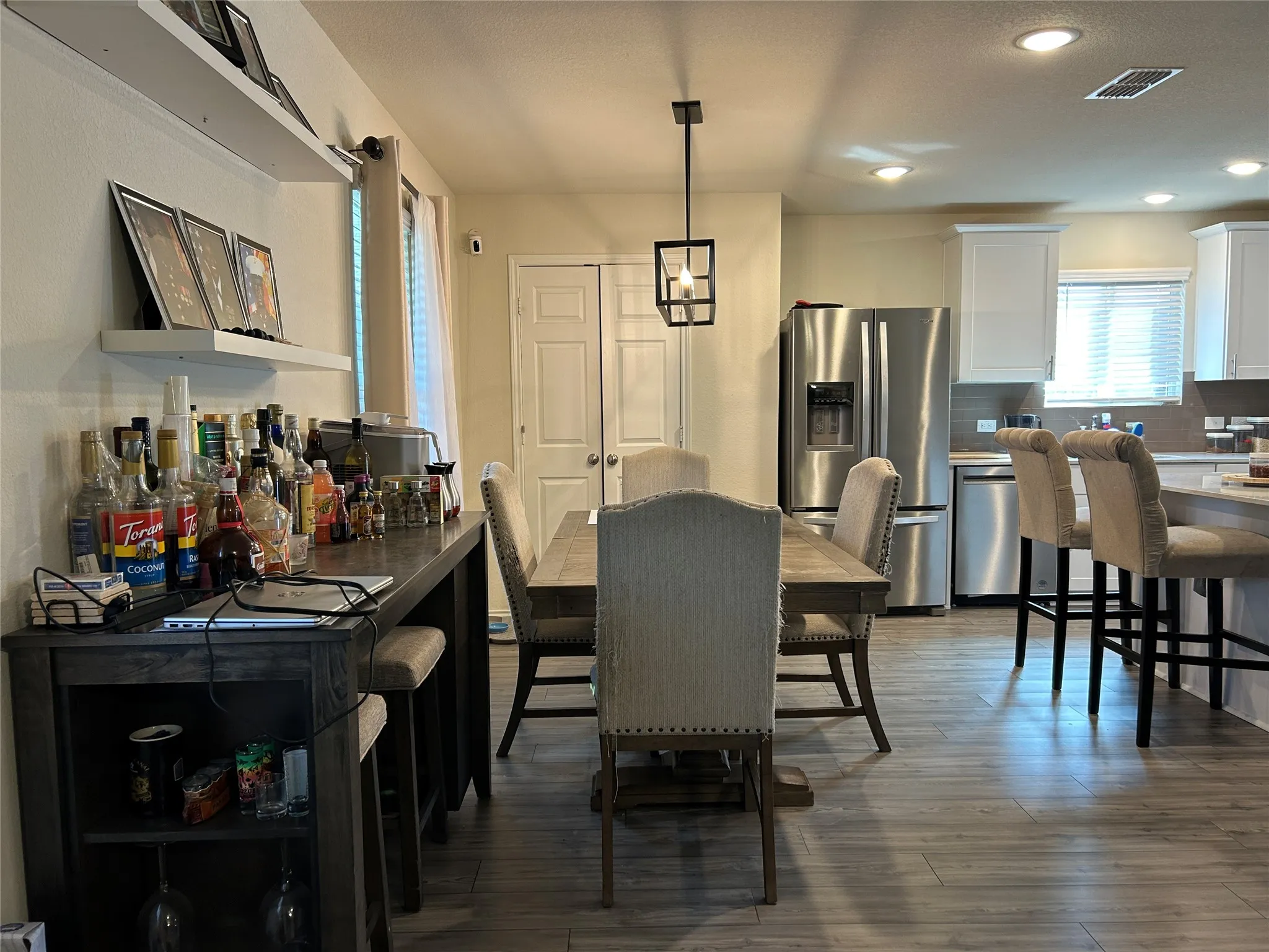 Dining room featuring dark wood-type flooring and recessed lighting
