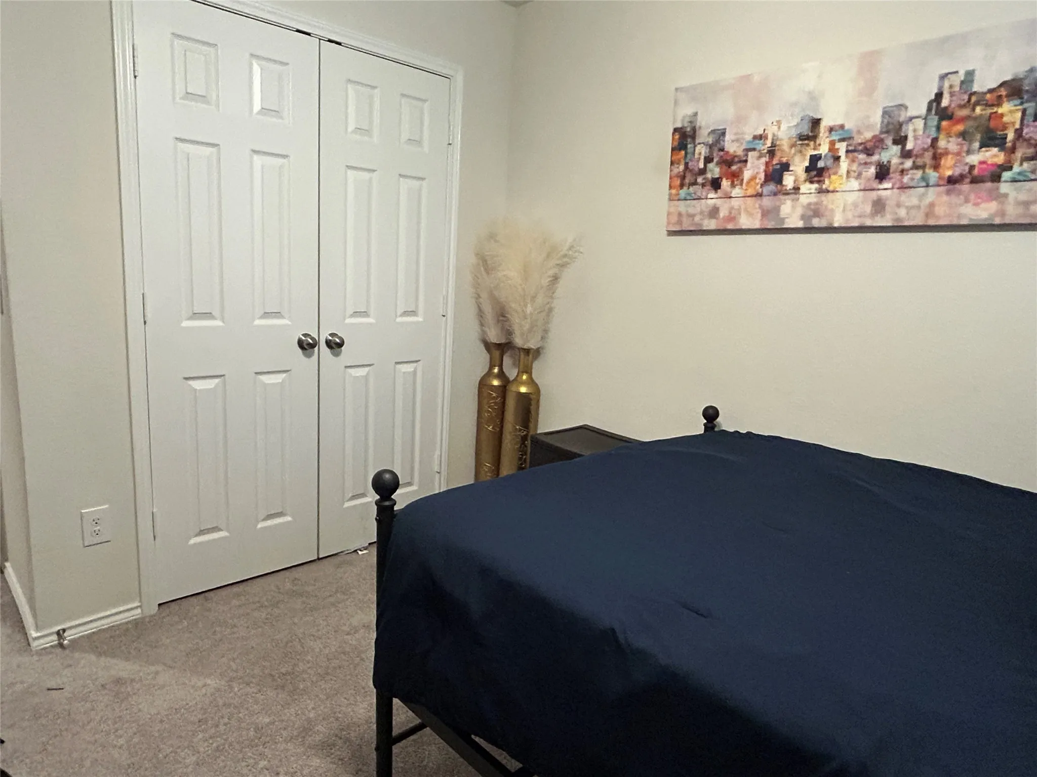 Bedroom with carpet and a closet