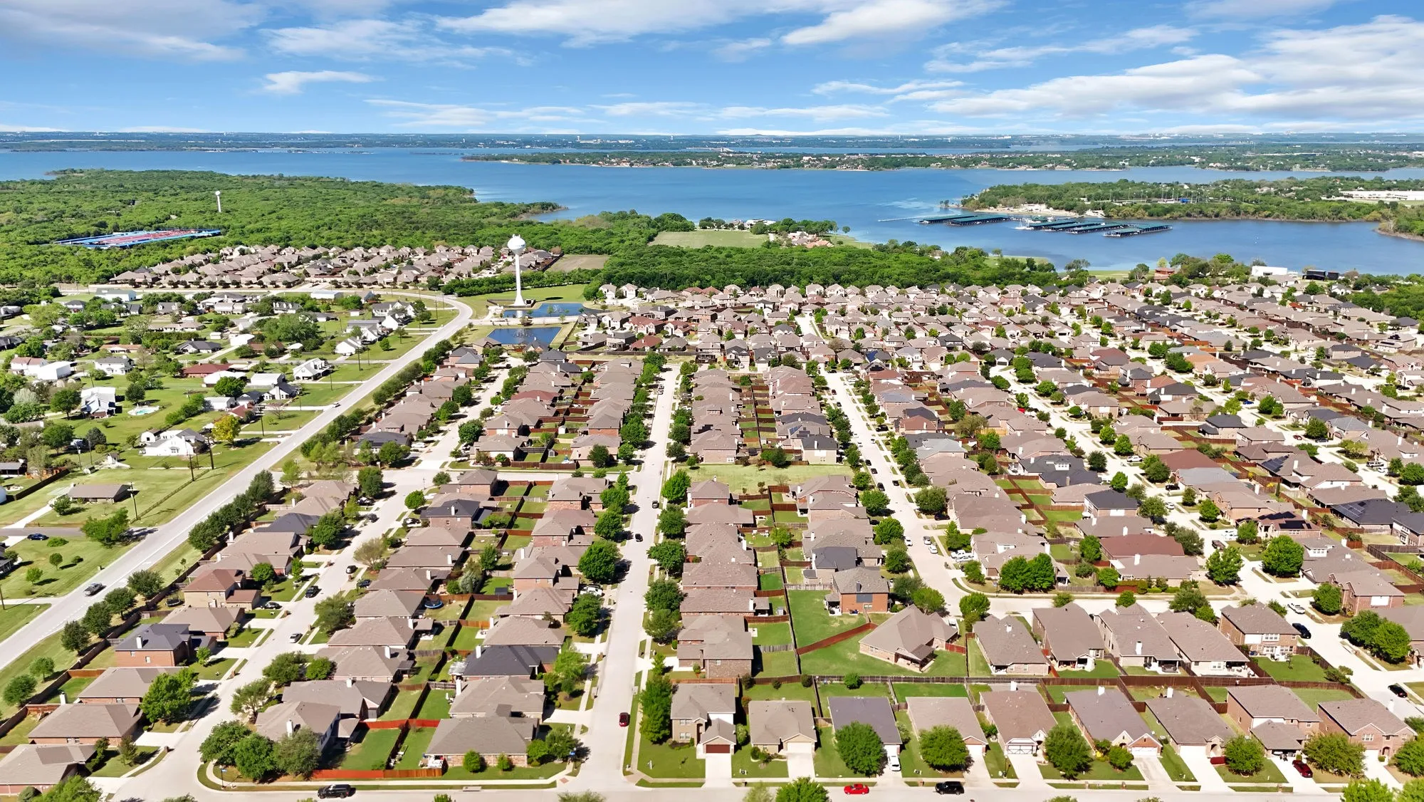 Aerial view of residential area featuring a large body of water