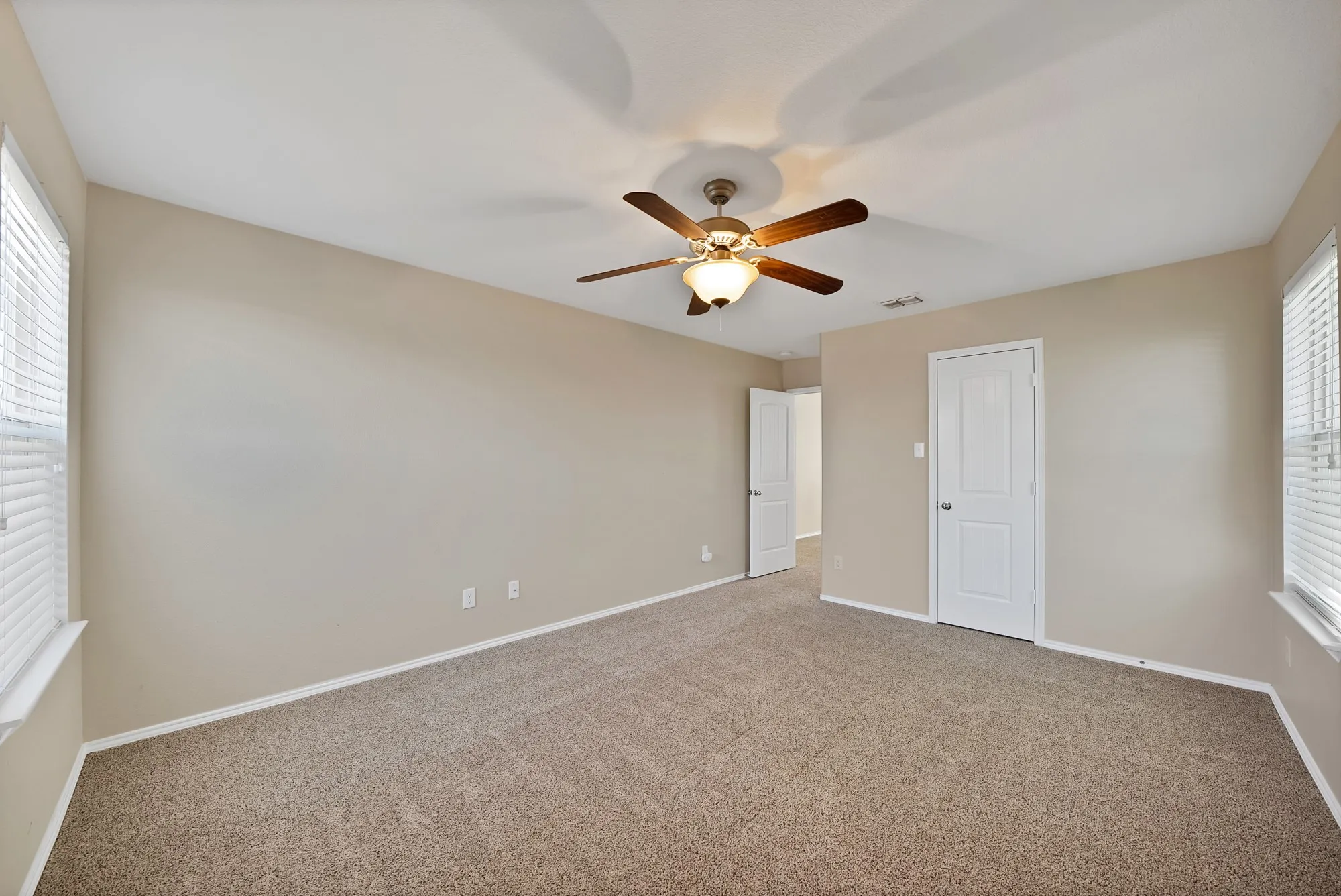 Unfurnished bedroom featuring ceiling fan and carpet flooring