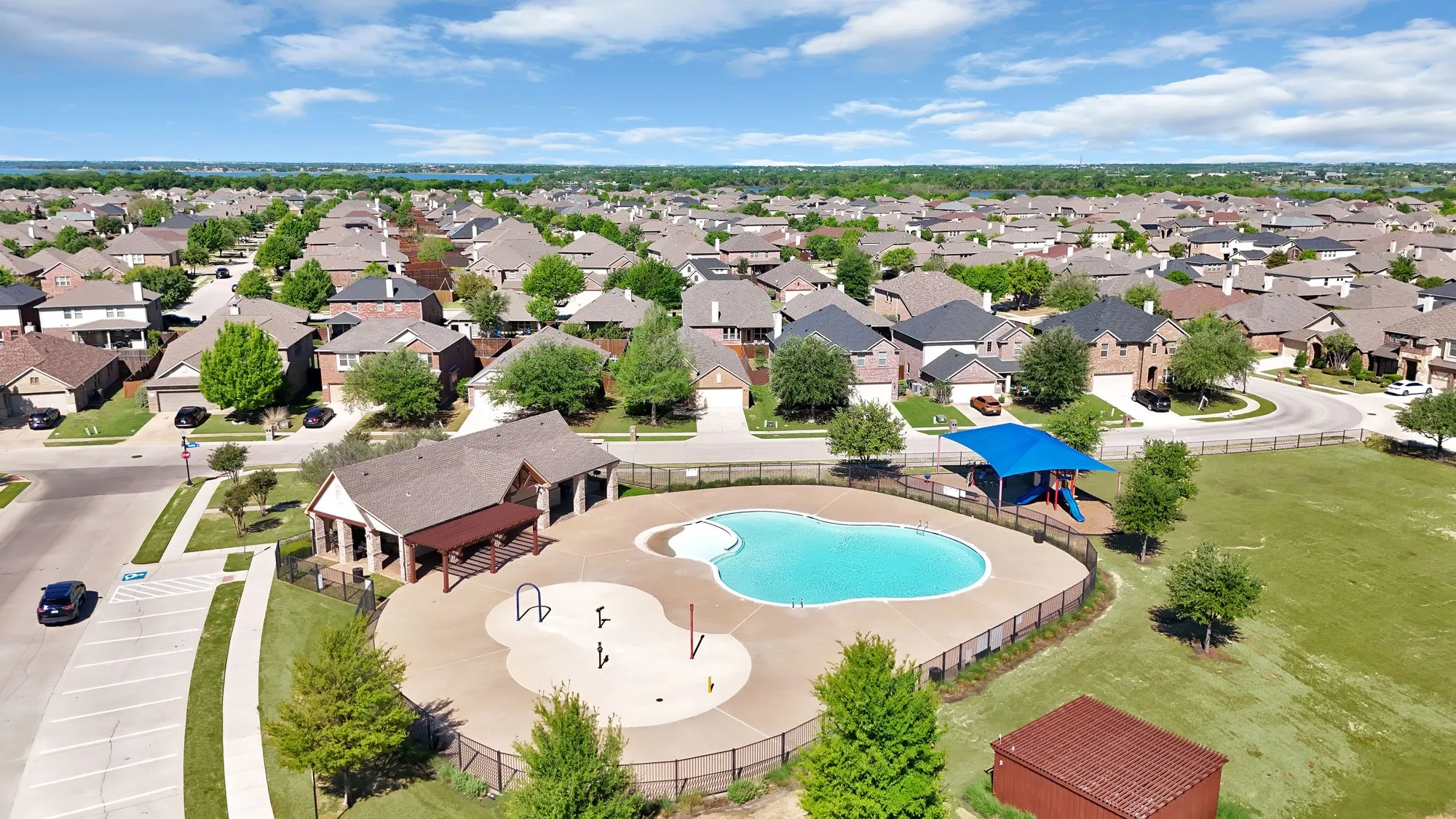 Aerial perspective of suburban area with a pool area