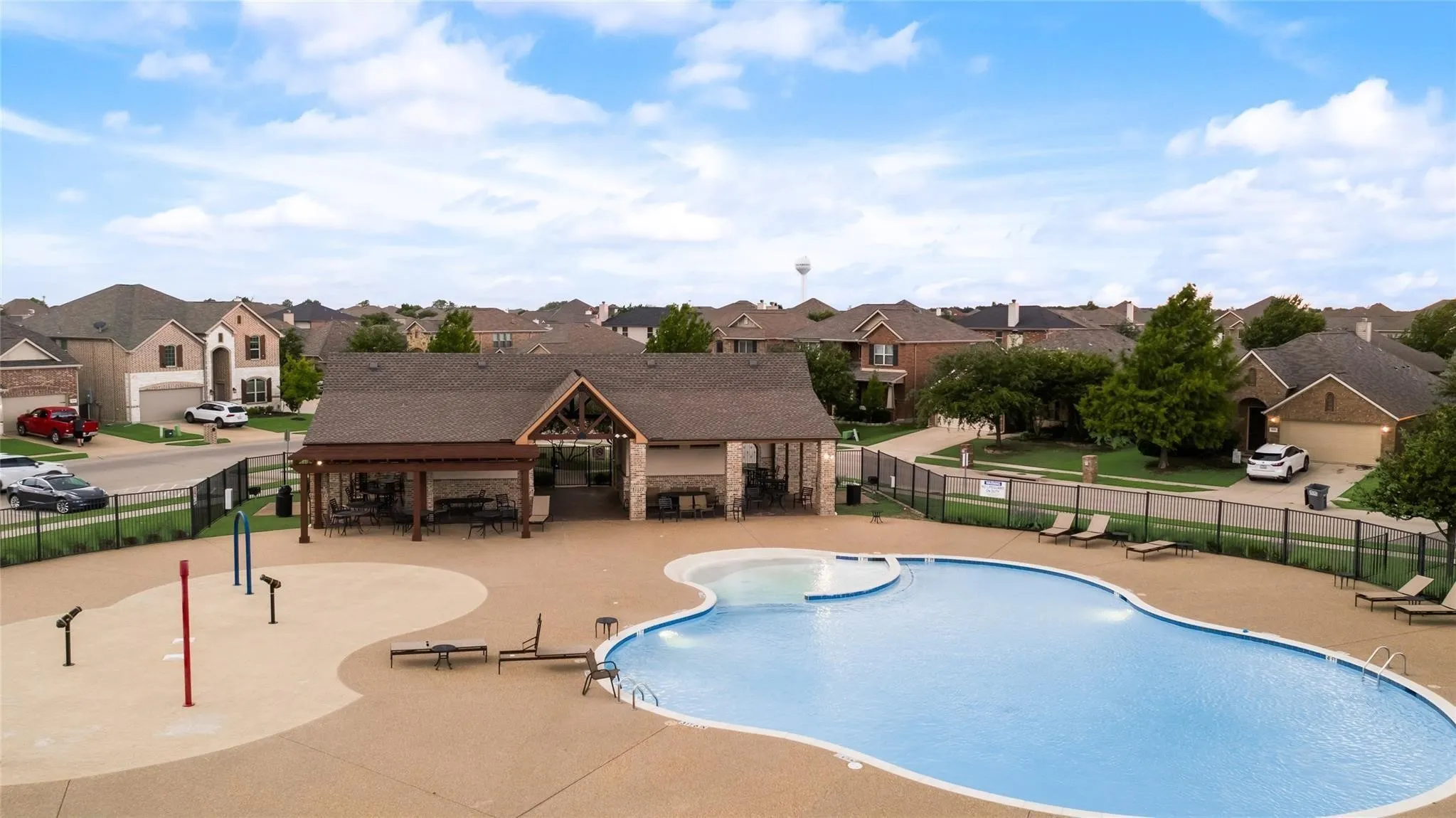 Community pool with a residential view and a patio