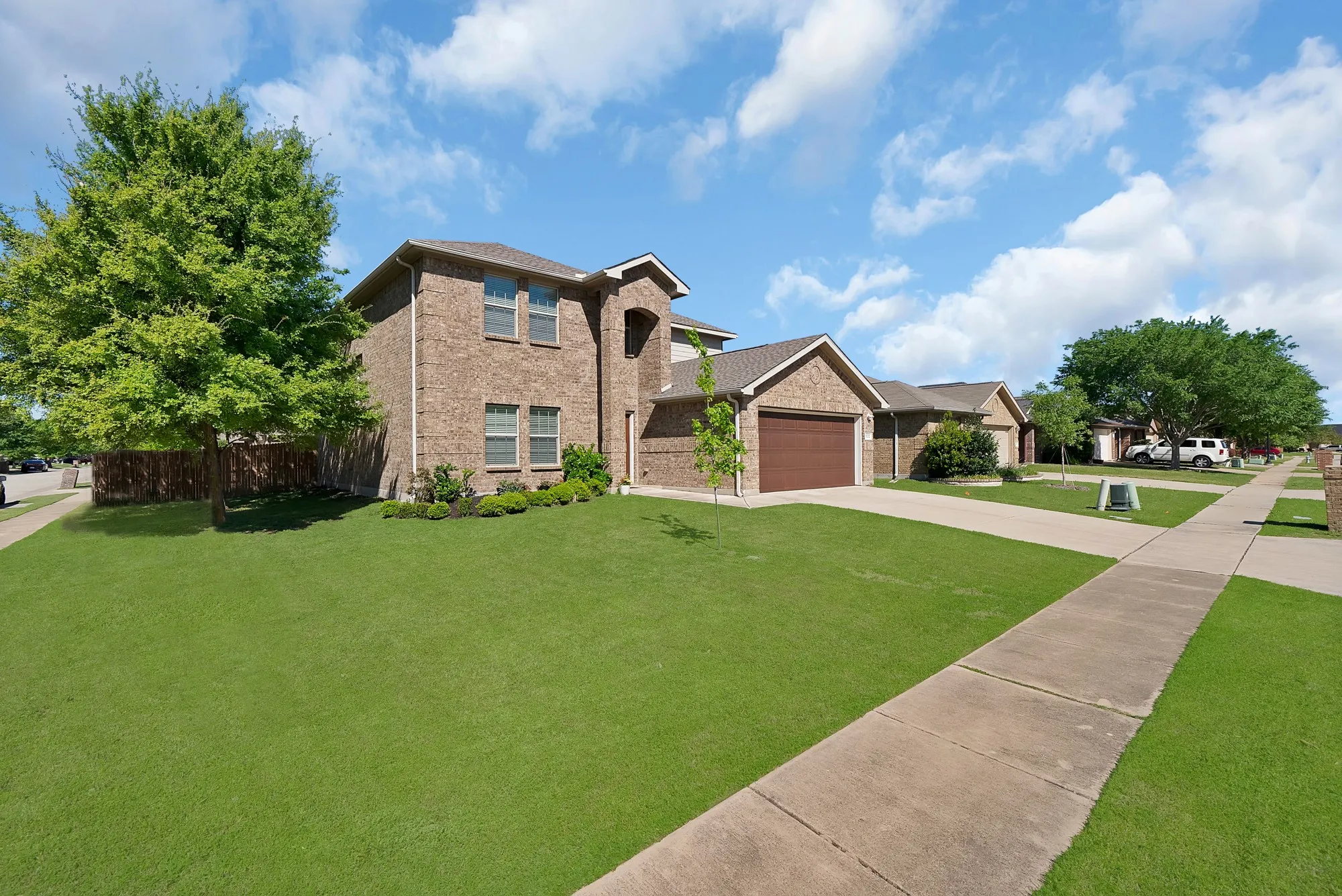 View of front of house featuring brick siding, an attached garage, and concrete driveway