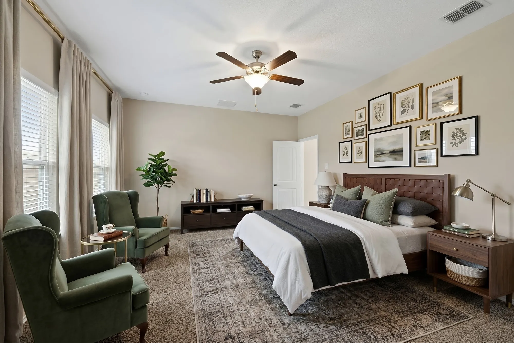 Carpeted bedroom with a ceiling fan