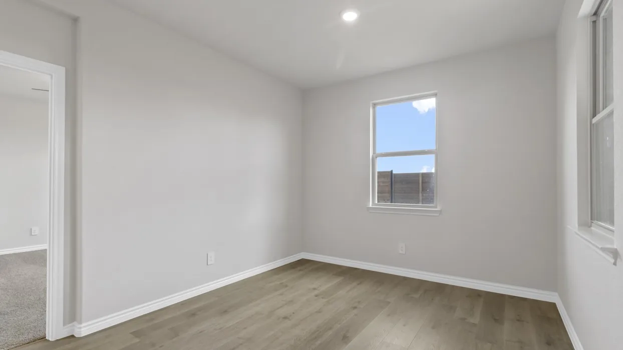 Unfurnished room featuring baseboards and light wood-type flooring