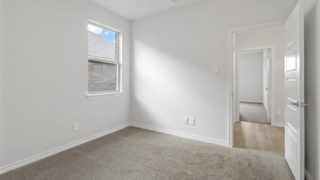 Spare room featuring light colored carpet and baseboards