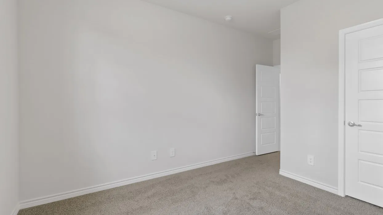 Unfurnished bedroom with carpet and baseboards