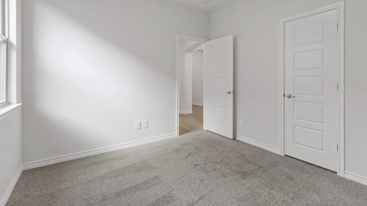 Unfurnished bedroom featuring carpet floors and baseboards
