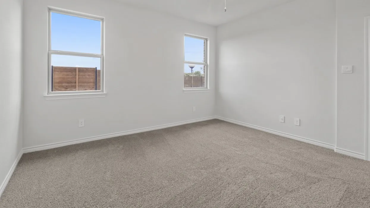 Empty room featuring light carpet and baseboards