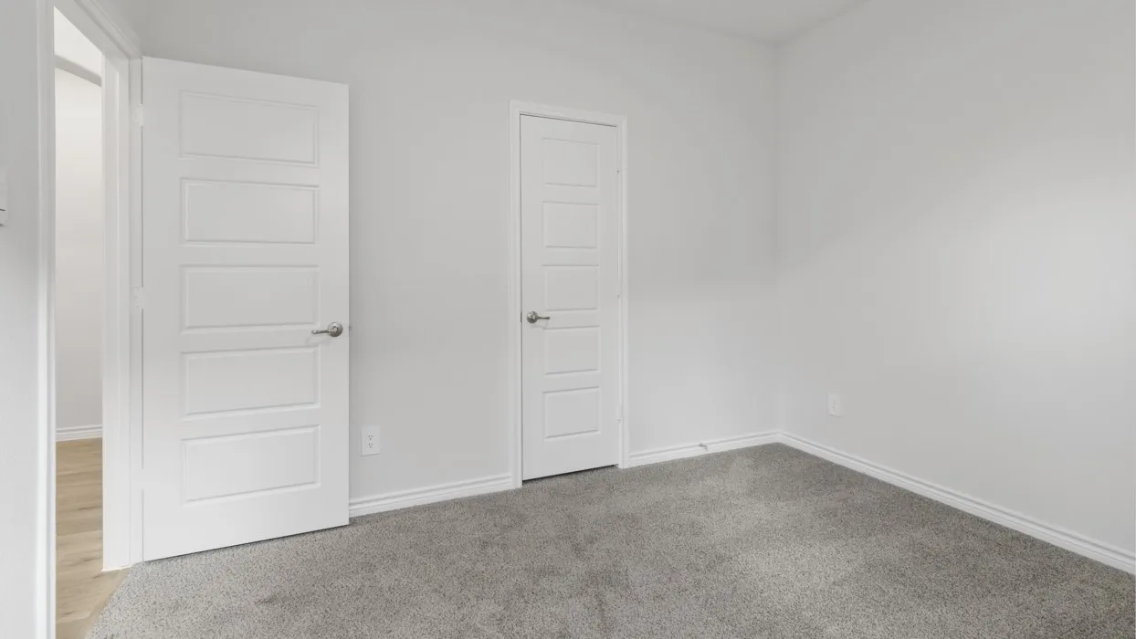 Unfurnished bedroom with carpet and baseboards