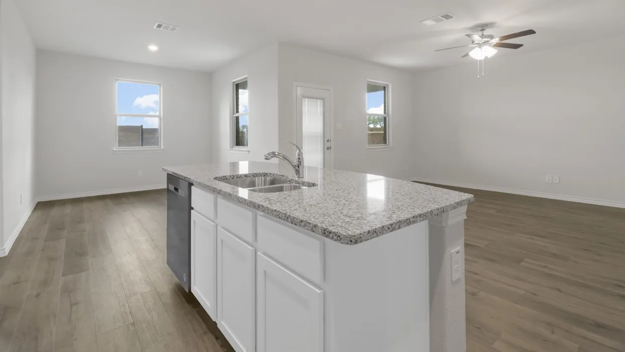 Kitchen with a ceiling fan, dark wood-type flooring, light stone countertops, white cabinetry, and open floor plan