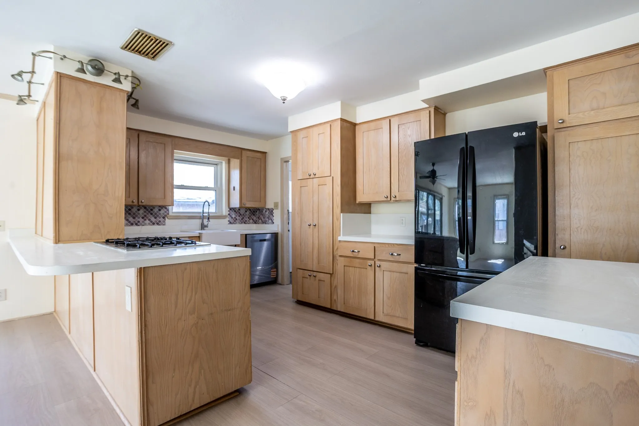 From the front entry you look all the way to the back den kitchen ara.
