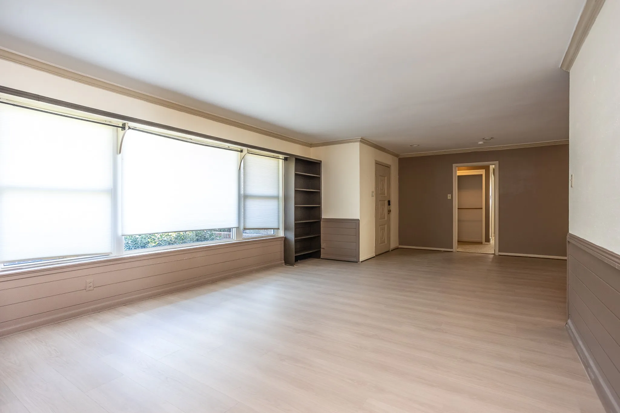 Living room showing entry door and door going to master suite.