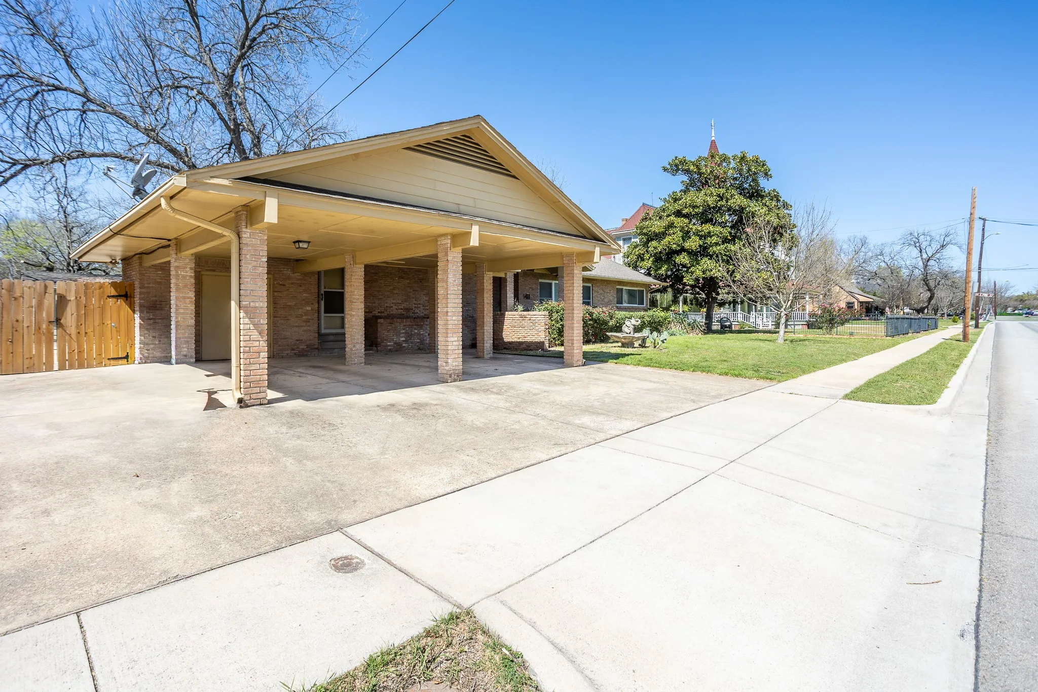 From the carport you ca to  the front door or storage room or door that opens into an office or sitting room for the master suite. Lots of concrete for parking andgates open to more oncret for more parking.