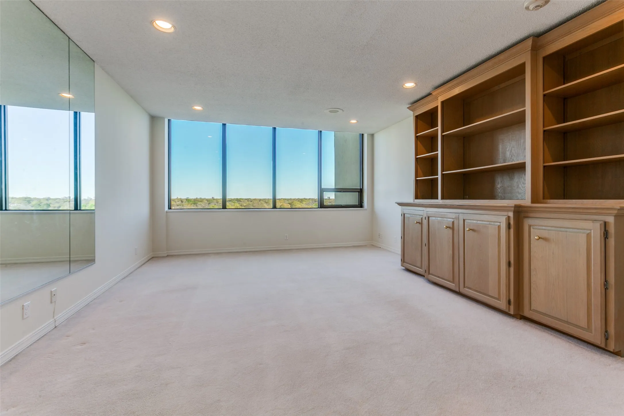 Primary bedroom with floor to ceiling custom built-ins.