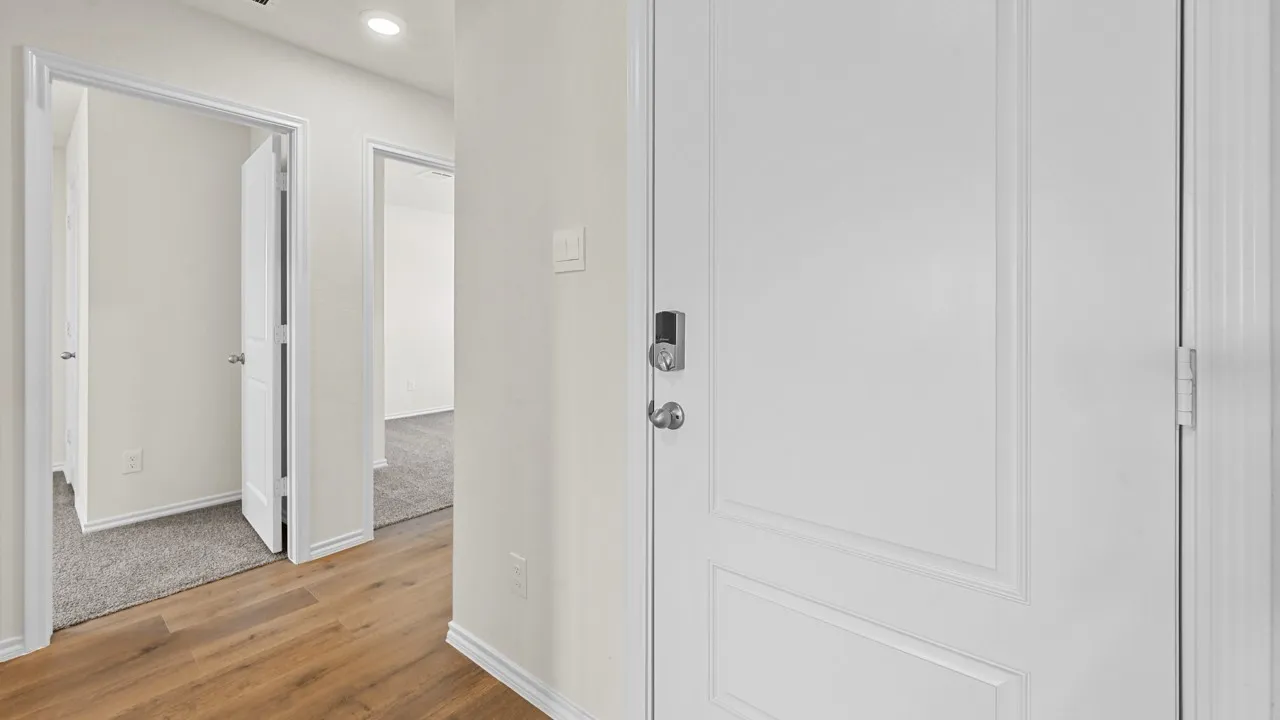 Corridor with light wood finished floors and recessed lighting