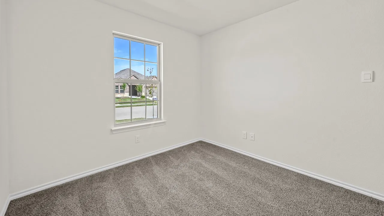 Empty room with carpet and baseboards