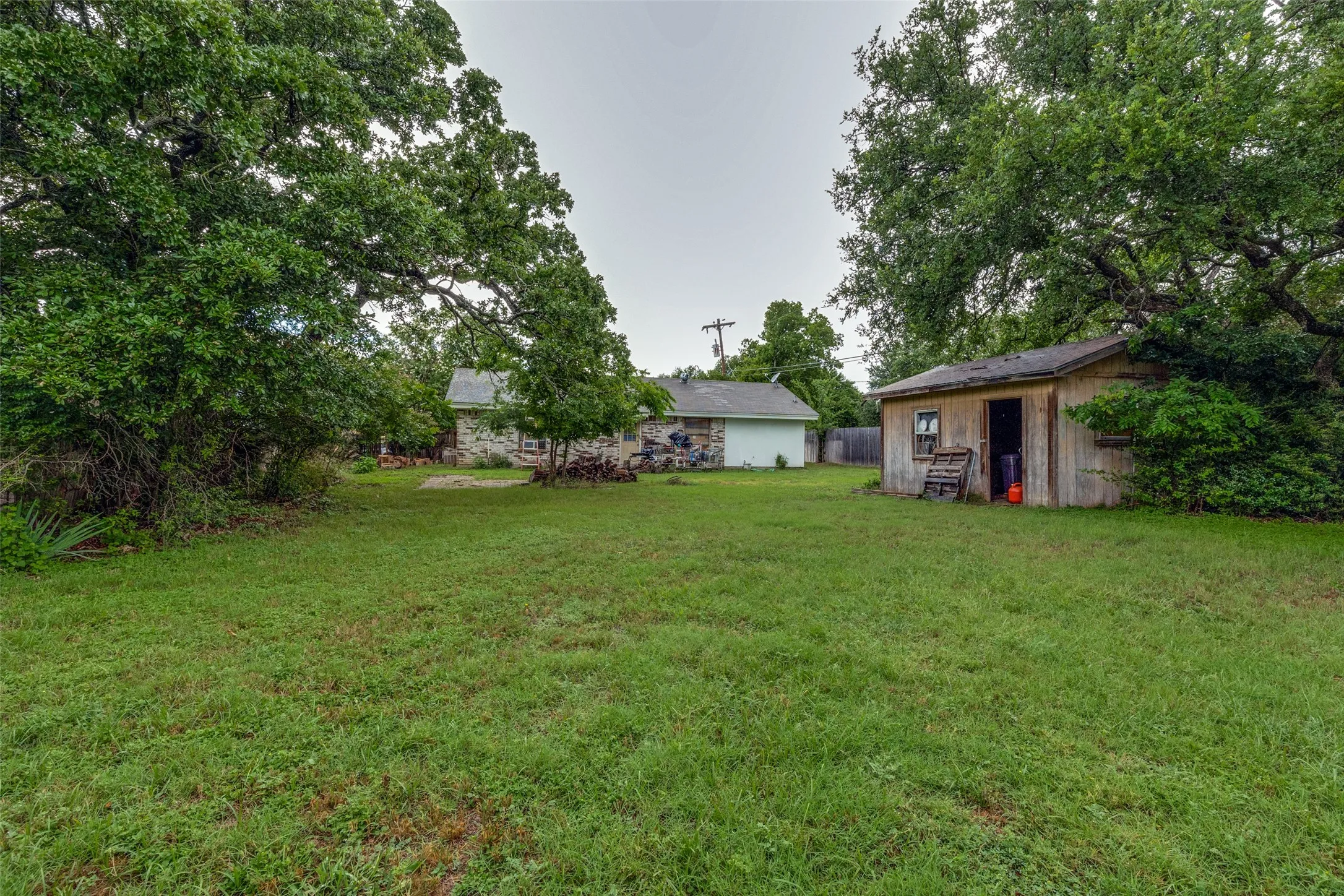 View of grassy yard with an outdoor structure
