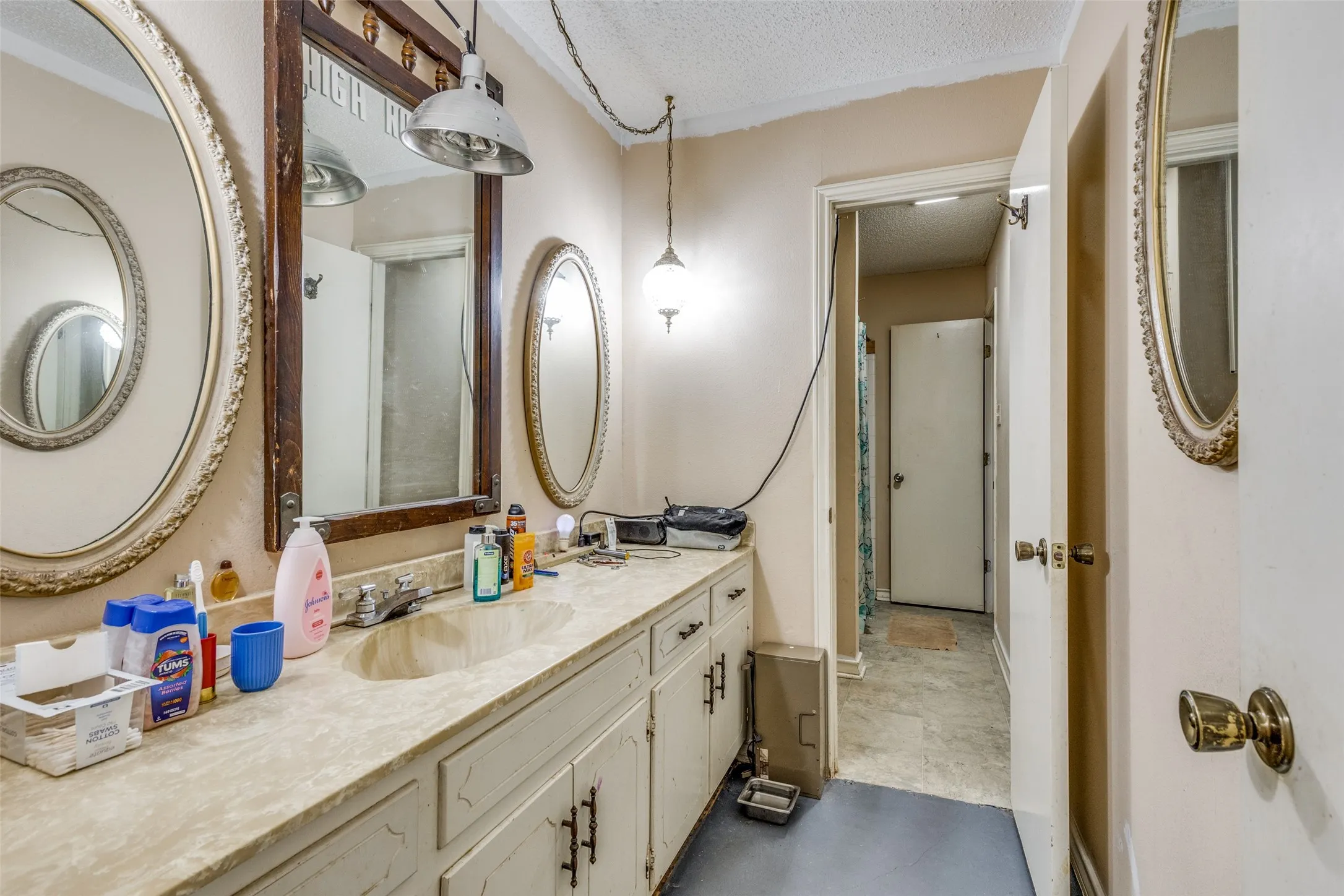 Bathroom featuring a textured ceiling and vanity