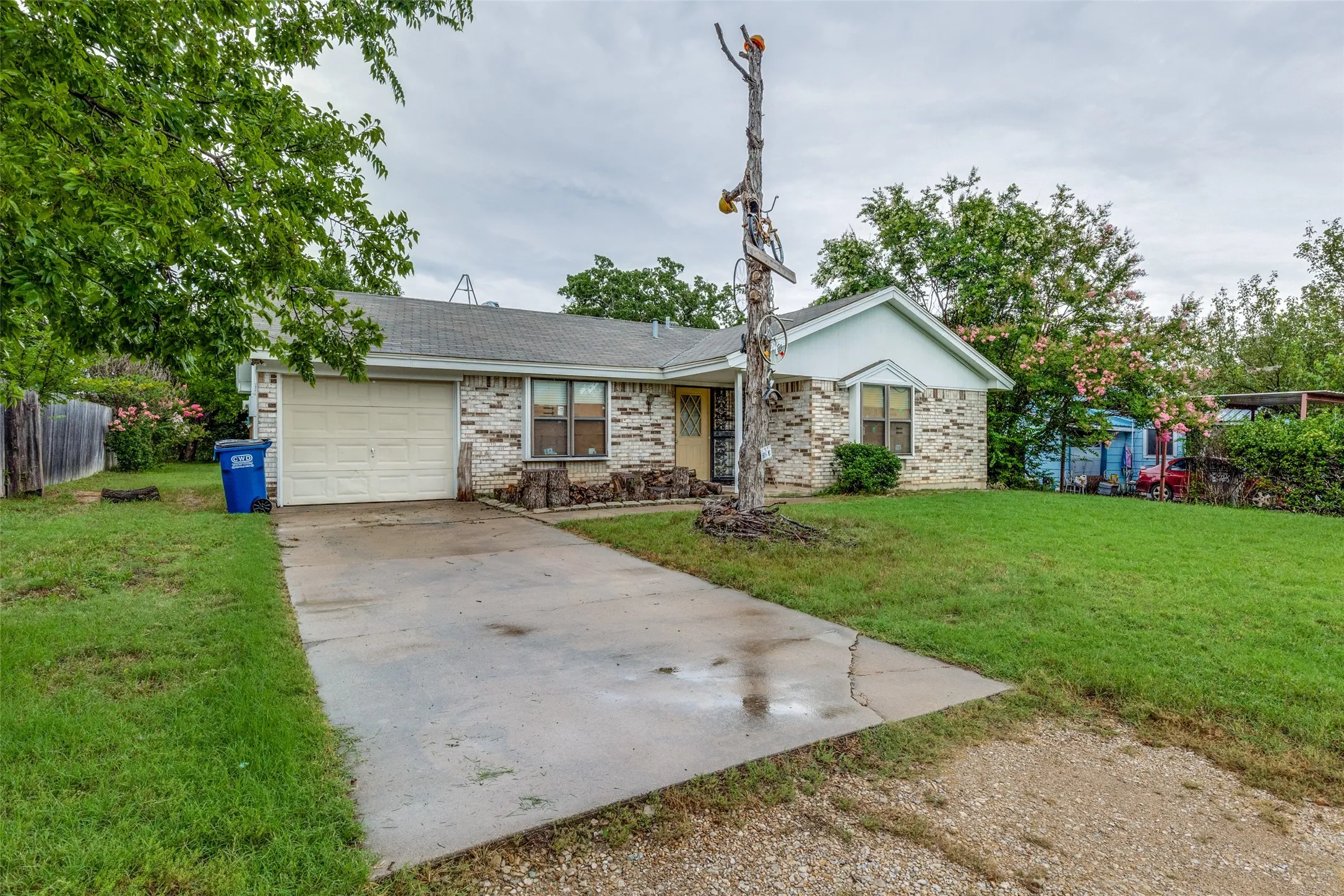 Ranch-style house with concrete driveway, a garage, and brick siding