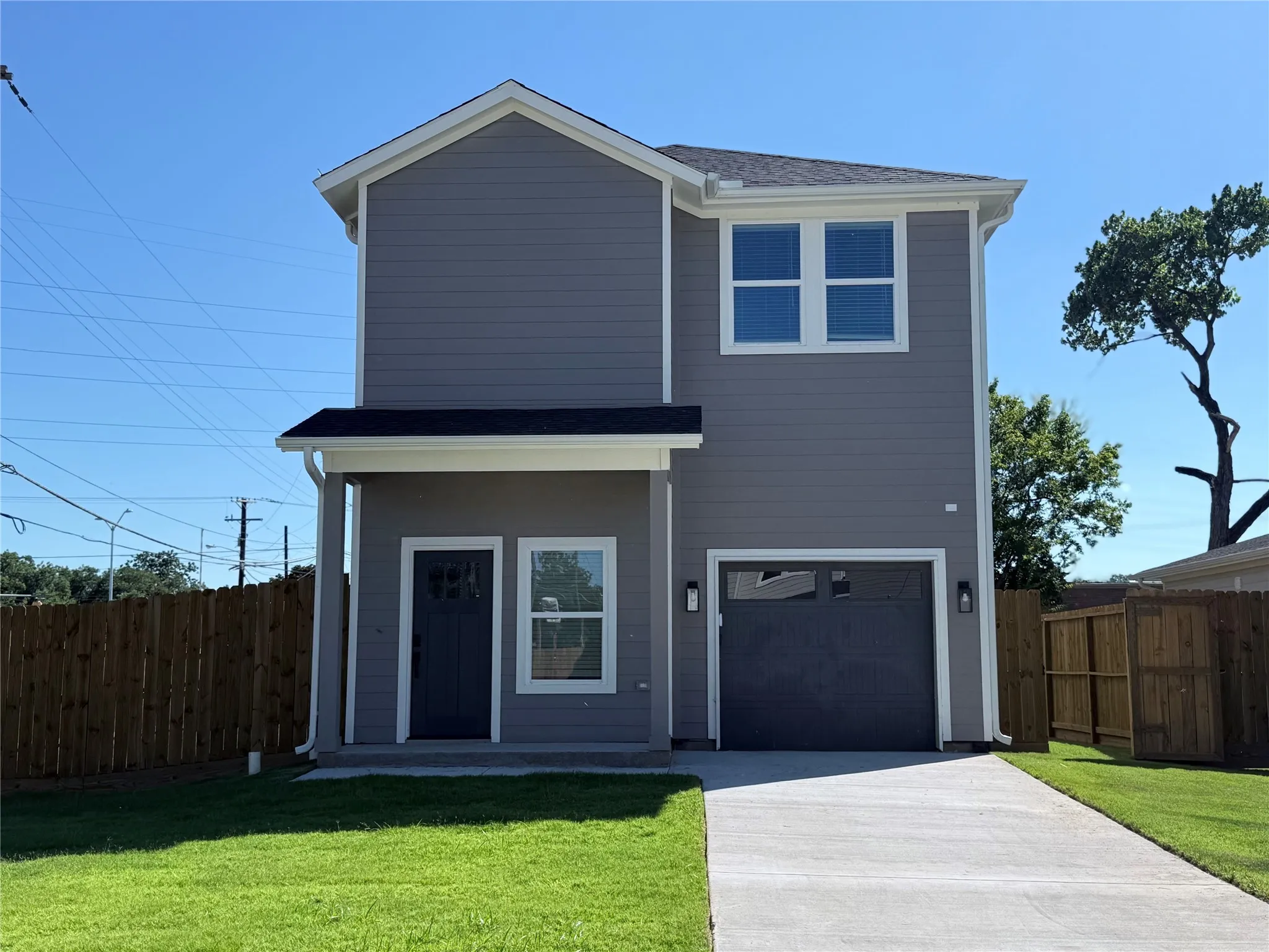 View of front of house featuring an attached garage and concrete driveway