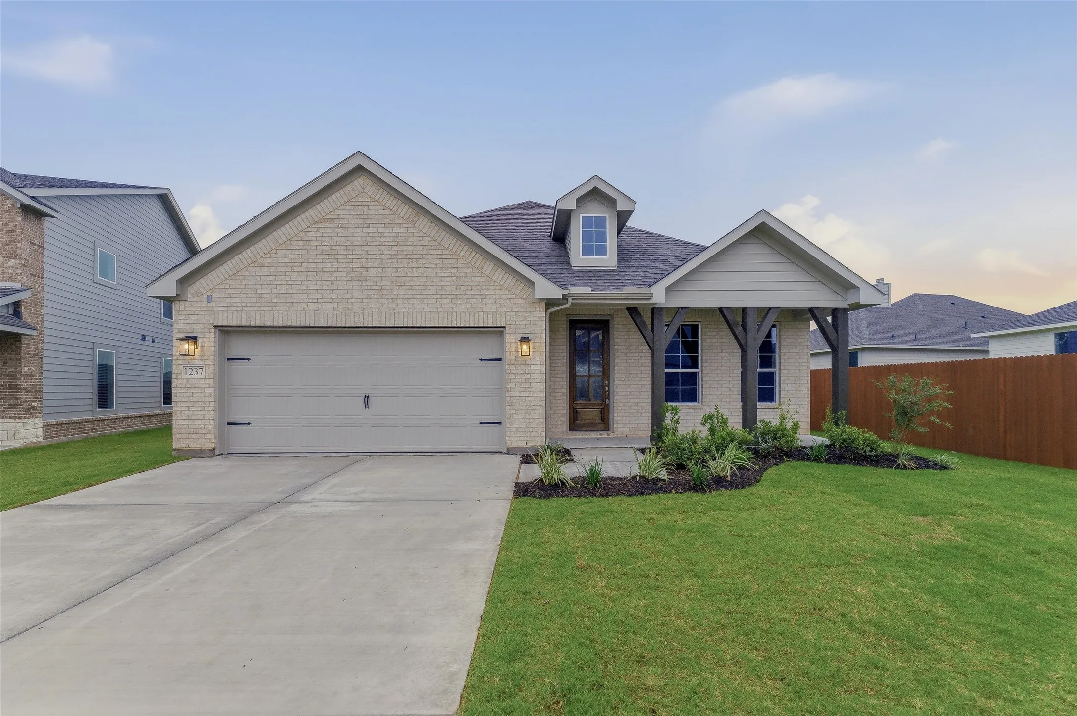 Light brick exterior with an attached two-car garage